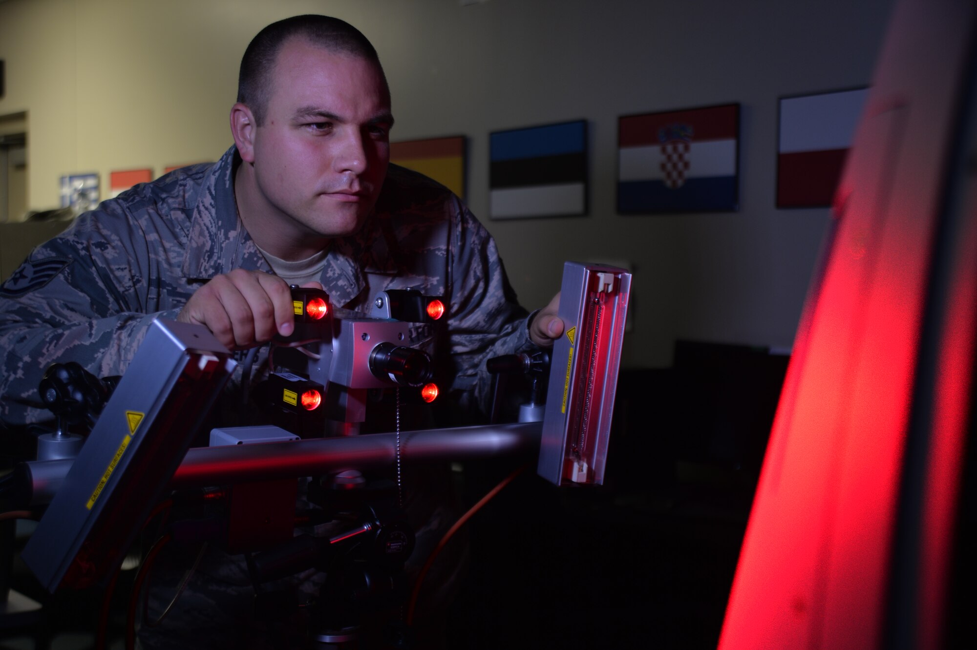 Staff Sgt Jason Walthers, 432nd Maintenance Squadron, non-destructive inspection technician looks for discrepancies in an aircraft piece at Creech Air Force Base, July 22, 2015. Walthers is training on the new NDI technology.   (U.S. Air Force photo by Senior Airman Adarius Petty)