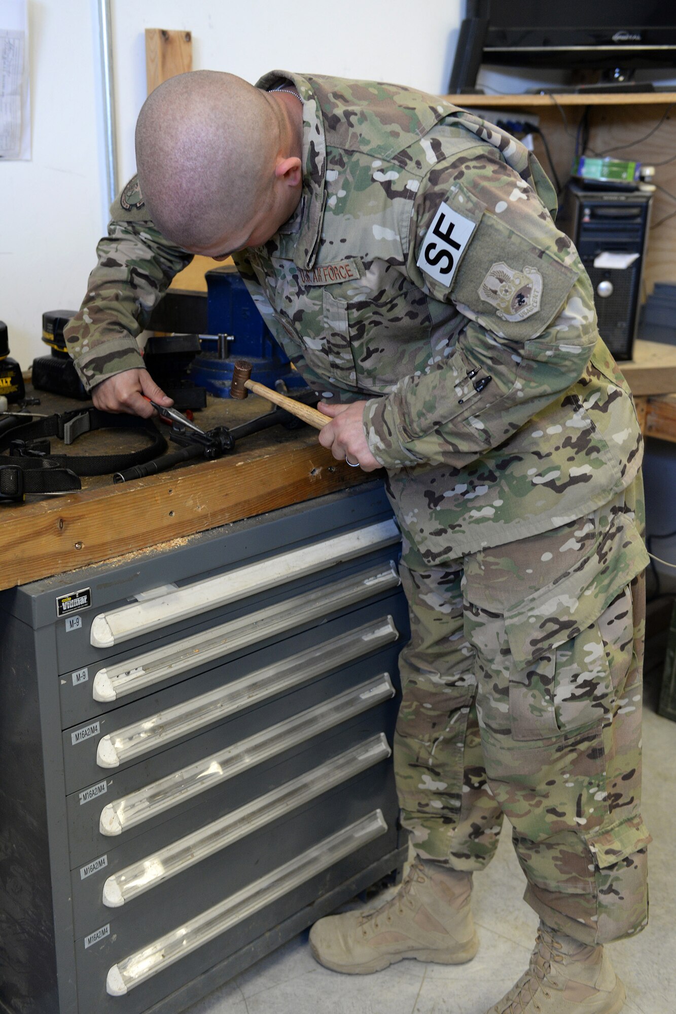 Tech. Sgt. Kevin Beers, 446th Security Forces Squadron combat arms instructor, out of Joint Base Lewis-McChord, Wash., searches for weapons parts for an M-4 rifle Aug. 10, 2015, at Bagram Air Field, Afghanistan. Beers is deployed as the CATM instructor for the 455th Expeditionary Security Forces Squadron. As Bagram’s only weapons repairman, he’s responsible for repairing weapons for the security forces squadron, logistics readiness squadron, Marines and all other units out of Bagram. (U.S. Air Force photo by Senior Airman Cierra Presentado)