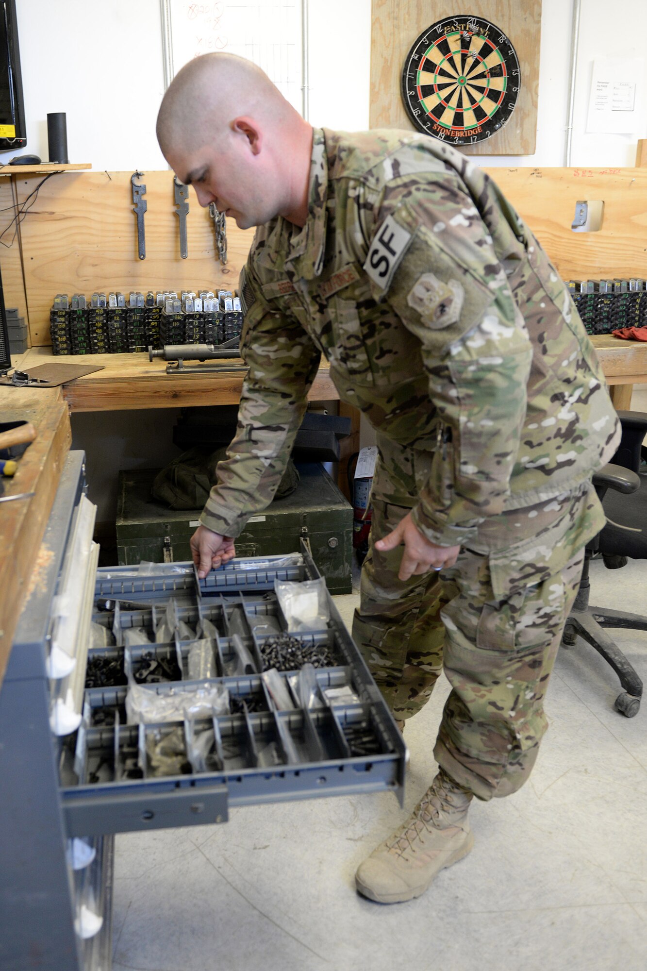 Tech. Sgt. Kevin Beers, 446th Security Forces Squadron combat arms instructor, out of Joint Base Lewis-McChord, Wash., searches for weapons parts for an M-4 rifle Aug. 10, 2015, at Bagram Air Field, Afghanistan. Beers is deployed as the CATM instructor for the 455th Expeditionary Security Forces Squadron. As Bagram’s only weapons repairman, he’s responsible for repairing weapons for the security forces squadron, logistics readiness squadron, Marines and all other units out of Bagram. (U.S. Air Force photo by Senior Airman Cierra Presentado)