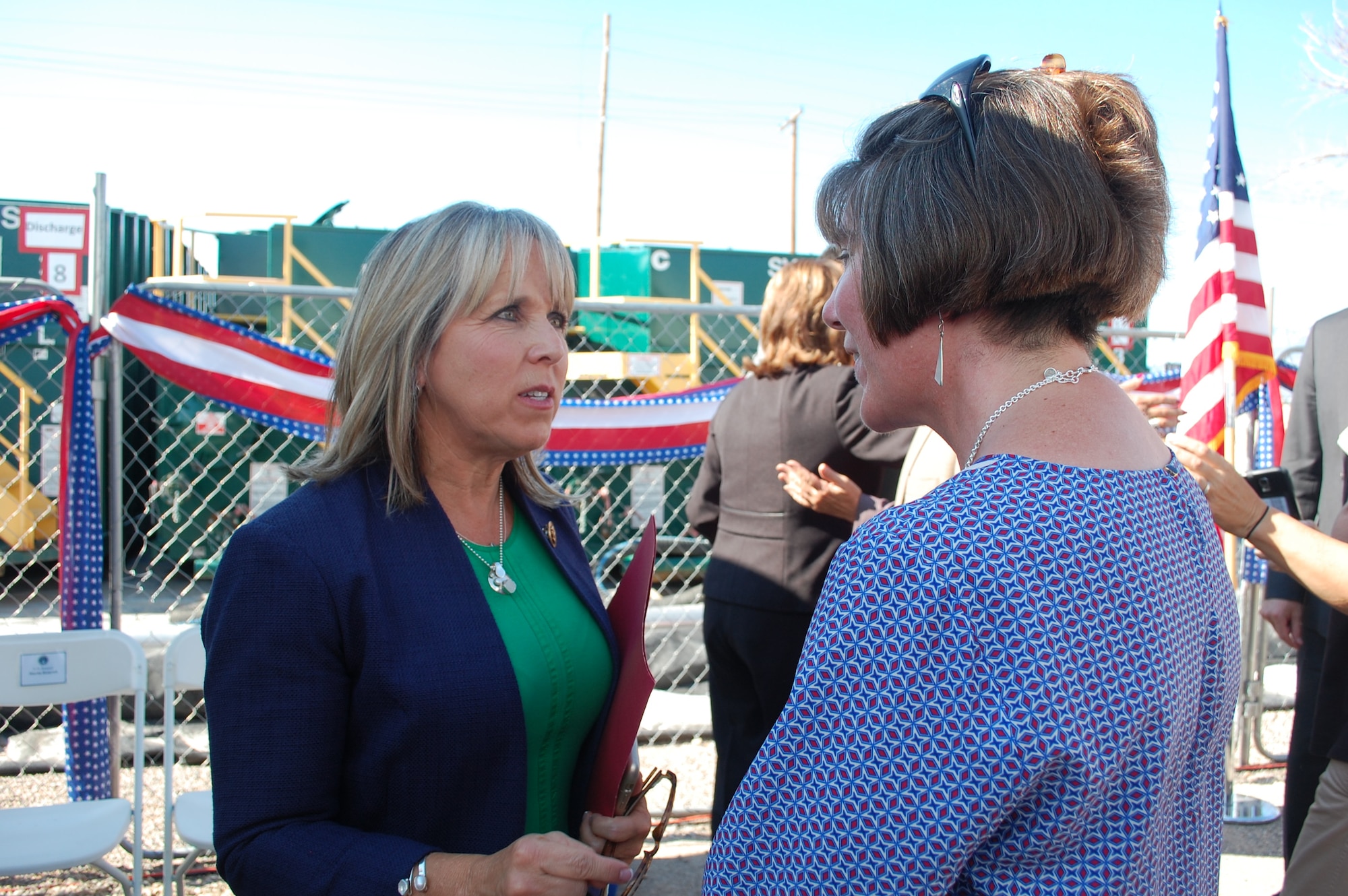 At left, Congresswoman Michelle Lujan Grisham speaks with Dr. Adria Bodour, the Air Force Civil Engineer Center’s technical lead for the Kirtland bulk fuels facility cleanup project, following a project milestone event Aug. 13. The event marked the installation of a groundwater treatment system and the successful extraction and treatment of fuel contamination associated with a fuel leak discovered in 1999. Since its activation in June, the system has treated more than two million gallons of water. (U.S. Air Force Photo/Jennifer Schneider/Released)