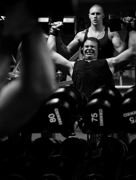 Senior Airman Paul Dell, 319th Logistics Readiness Squadron vehicle operator, performs a 105-pound dumbbell military press during his shoulder exercise at the fitness center on Grand Forks Air Force Base, North Dakota, on Aug. 12, 2015. Dell benefits from an active lifestyle and helps optimize his health while maintaining a higher level of readiness. (U.S. Air Force photo by Senior Airman Xavier Navarro/released)