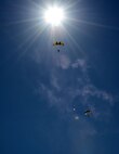 U.S. Army Golden Knights descends under canopy during the national anthem at the 2015 Dakota Thunder airshow and open house at Ellsworth Air Force Base, S.D., Aug. 15th, 2015. The Golden Knights were part of the opening ceremonies of the air show. (U.S. Air Force photo by Airman 1st Class James L. Miller/Released)