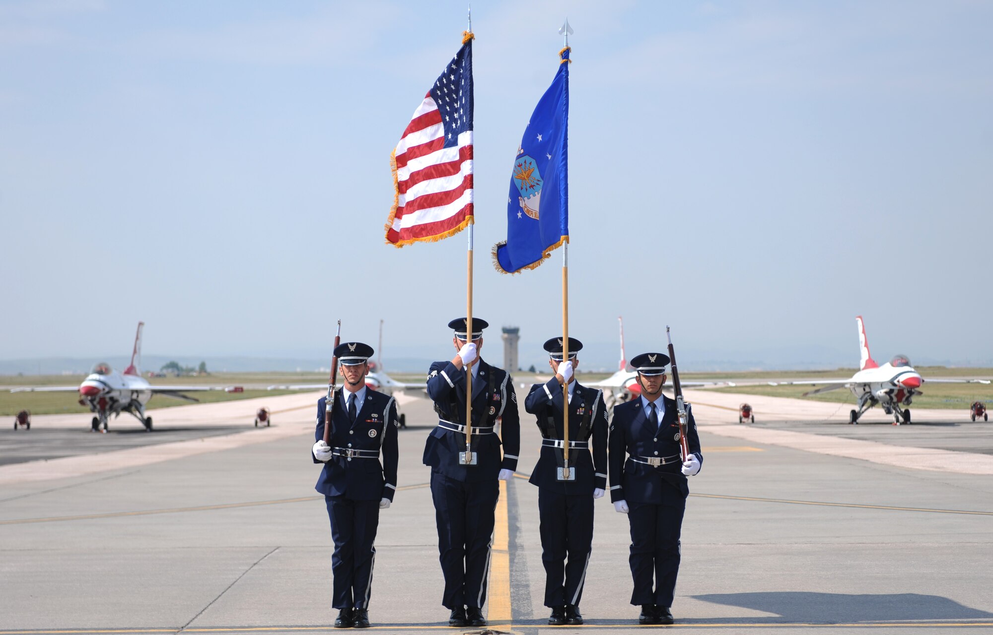 Honor Guardsmen from the 28th Bomb Wing presents the colors in front of the Thunderbirds at the 2015 Dakota Thunder airshow and open house, Ellsworth Air Force Base, S.D., Aug. 16, 2015. The airshow aerial demonstration teams performed for more than 51,000 attendees and showcased both military and civilian aircraft. (U.S. Air Force photo by Airman Sadie Colbert/Released)