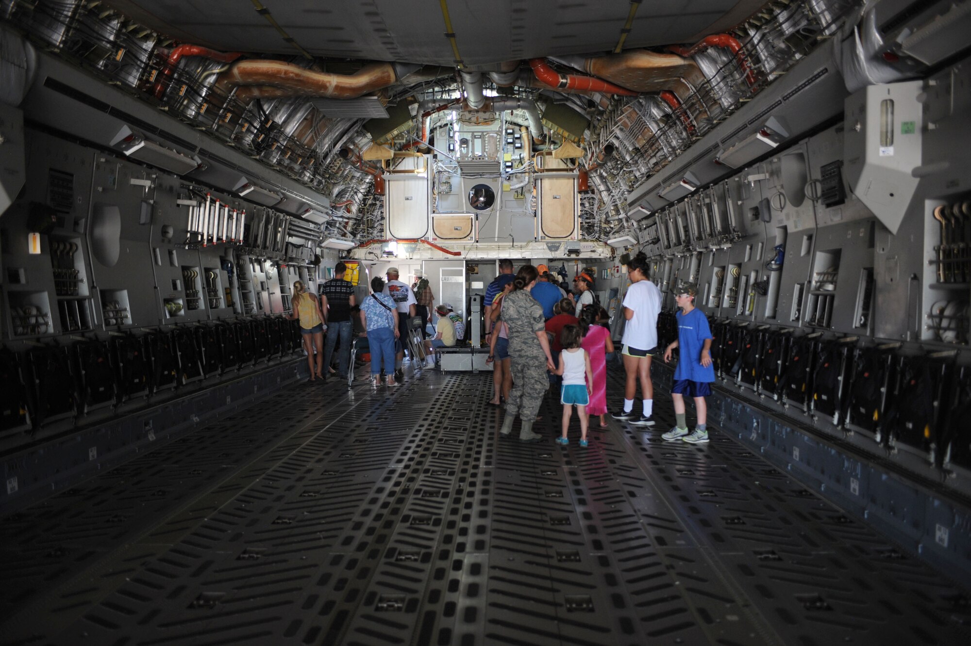 Attendees at the 2015 Dakota Thunder airshow and open house explore the interior of an EC-130H at Ellsworth Air Force Base, S.D., Aug. 15, 2015. The airshow featured various static aircraft from across the nation among the many aerial demonstrations throughout the two-day event. (U.S. Air Force photo by Airman 1st Class Denise M. Nevins/Released)