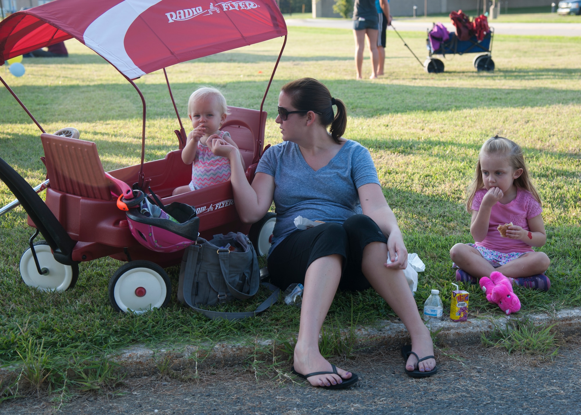 Claire Roschen and her daughters Elsie and Ashley enjoy some of the free food available at USO Delaware Movie on the Lawn event Aug. 14, 2015, across from the Youth Center on Dover Air Force Base, Del. Free food and beverages were offered prior to the evening showing of “Finding Nemo.” (U.S. Air Force photo/Master Sgt. Jeremy Larlee)