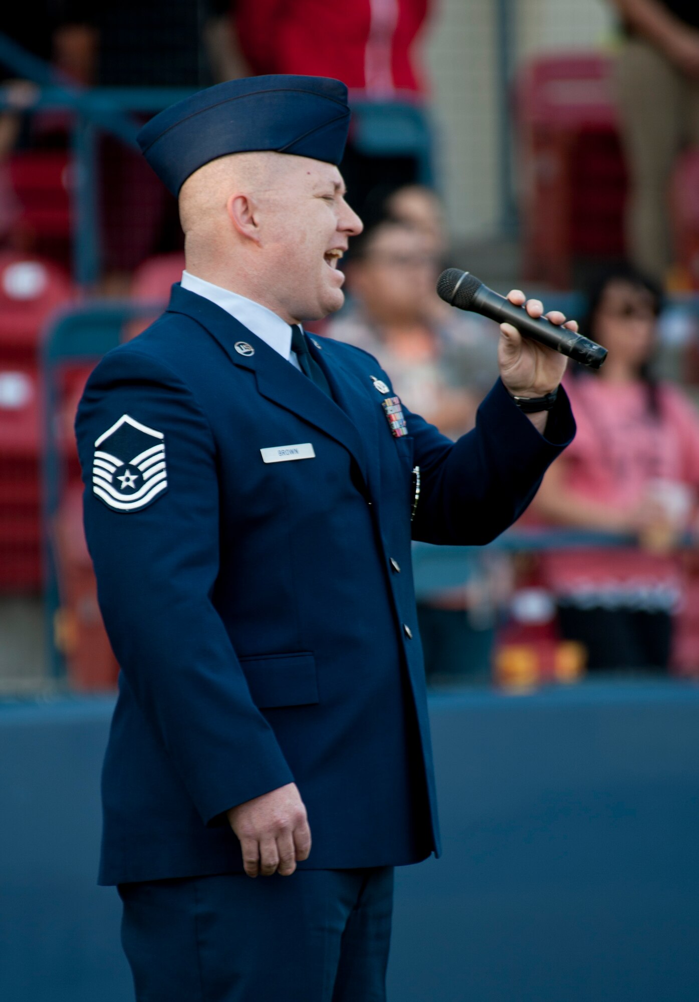 Master Sgt. Mike Brown, 368th Recruiting Squadron flight chief, sings the national anthem before the Spokane Indians baseball game Aug. 15, 2015, at Avista Stadium in Spokane, Wash. Brown was selected as the military member to sing the national anthem while other members unfurled a flag in honor of military appreciation night. (U.S. Air Force photo/Airman Sean Campbell)