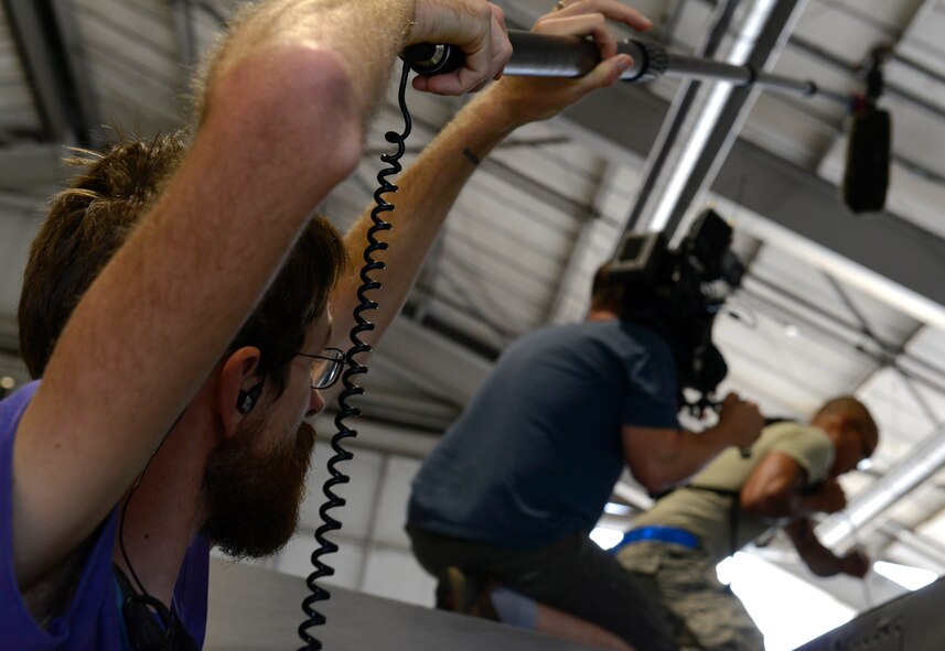 A news crew hired by the Smithsonian Institute records supporting shots of an Airman working on a F-16CM Fighting Falcon at Shaw Air Force Base, S.C., Aug. 18, 2015. The footage is being used to share the F-16’s history at Shaw and will air on the show “Air Warriors” on the Smithsonian Channel. (U.S. Air Force photo by Airman 1st Class Christopher Maldonado/Released)