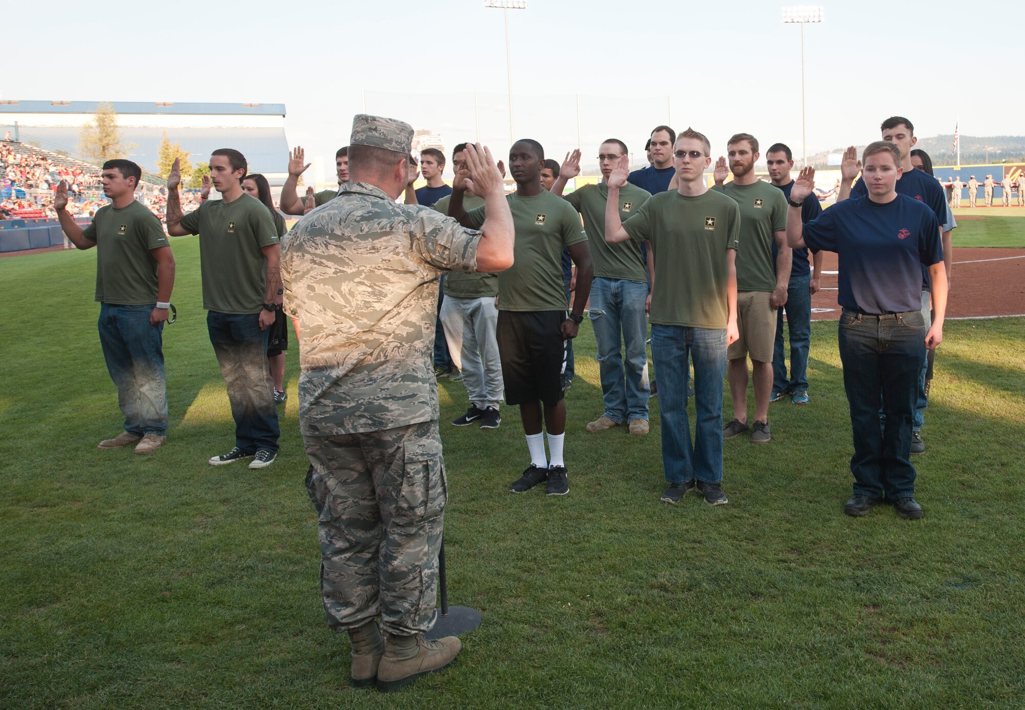 Col. Brian McDaniel, 92nd Air Refueling Wing commander, swears in more than 15 Army and Marine recruits Aug. 15, 2015, at Avista Stadium in Spokane, Wash. McDaniel gave the oath of enlistment to recruits which is a statement that every service member must promise and adhere to for their entire military career. (U.S. Air Force photo/Airman Sean Campbell)