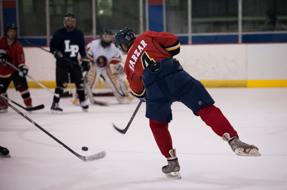 Airman 1st Class Justin Barzar, Joint Base Andrews Guardians defensemen, shoots the puck during a game verses the Kraken, a Maryland based hockey team, at Capital Clubhouse in Waldorf, Md., Aug. 5, 2015. Barzar is one of six defensemen on the 34 player Guardians roster. (U.S. Air Force photo/Airman 1st Class Philip Bryant)