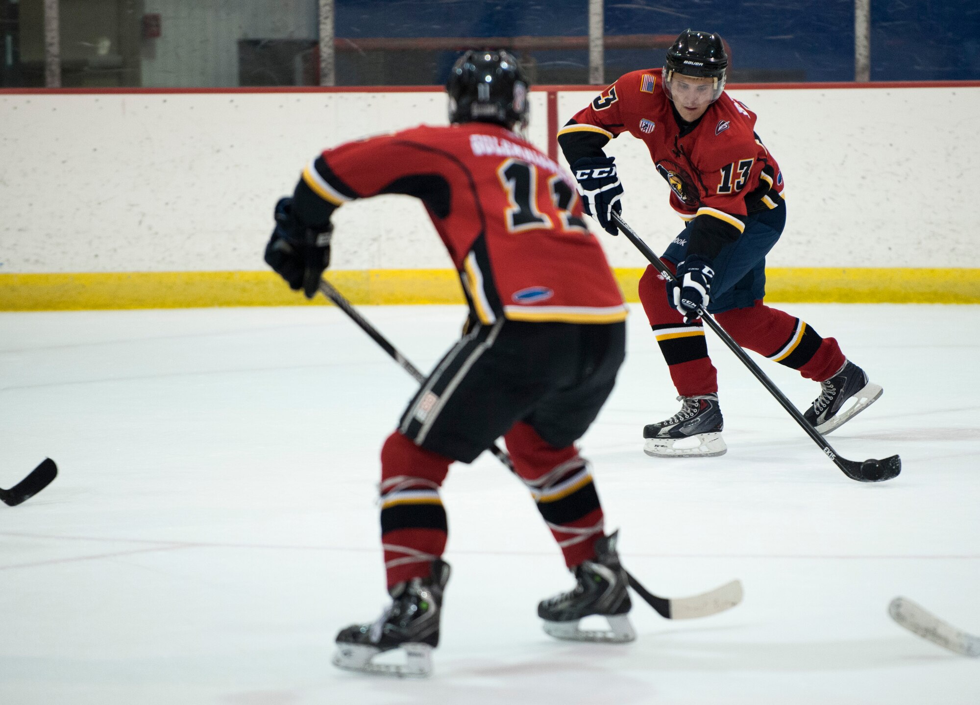 Staff Sgt. Cory Mercurio, Joint Base Andrews Guardians forward, passes the puck to Maj. Brent Golembiewski, JBA Guardians forward, during a game at Capital Clubhouse in Waldorf, Md., Aug. 5, 2015. Golembiewski, the Guardians captain, and Mercurio have played together for a year and were part of the undefeated 2015 Guardians team that won the Washington Division Championship. (U.S. Air Force photo/Airman 1st Class Philip Bryant)