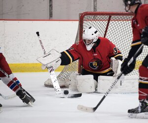 1st Lt. Griffin Holavchock, Joint Base Andrews Guardians goalie, blocks a shot during a game verses the Kraken, a Maryland based hockey team, at Capital Clubhouse in Waldorf, Md., Aug. 5, 2015. Holavchock made 23 saves and held the Kraken scoreless the last six minutes of the game. (U.S. Air Force photo/Airman 1st Class Philip Bryant)