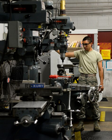 Airman 1st Class Kamiana Jardine, 2nd Maintenance Squadron metals technology apprentice, inspects his work at Barksdale Air Force Base, La., Aug. 4, 2015. Manual and computer numerically-controlled metal-working machines, mills and lathes are used to manufacture and repair parts. (U.S. Air Force photo/Senior Airman Jannelle Dickey)