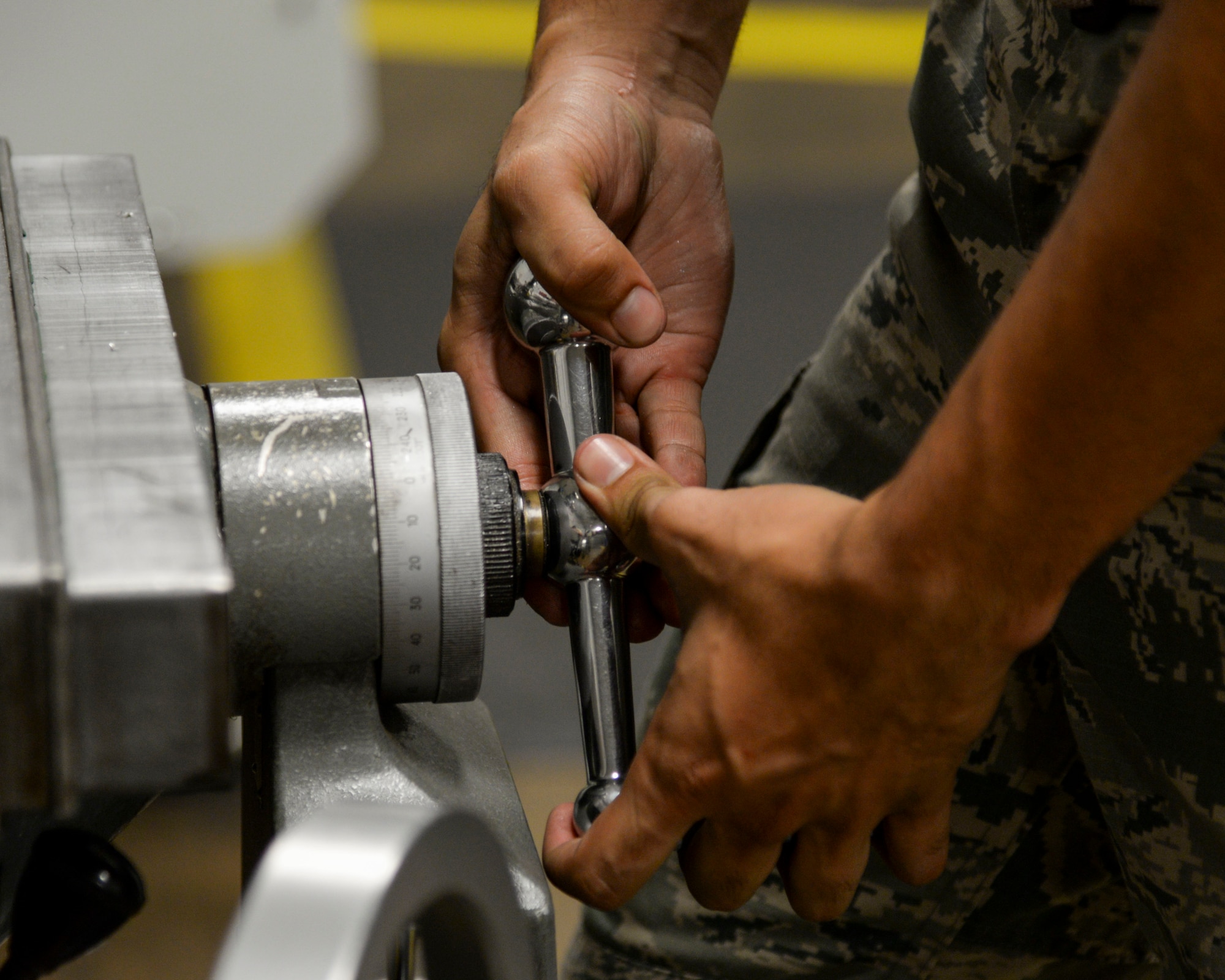 Airman 1st Class Kamiana Jardine, 2nd Maintenance Squadron metals technology apprentice, turns a handle on a manual mill at Barksdale Air Force Base, La., Aug. 4, 2015. Precision and attention to detail are imperative to the metals tech mission.  (U.S. Air Force photo/Senior Airman Jannelle Dickey)