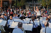 Special guest conductor Colonel (ret.) Arnold Gabriel leads the U.S. Air
Force Concert Band at the National Harbor Plaza stage, MD on Aug. 15, 2015.
The performance commemorated the 70th anniversary of the end of World War II
and celebrated "The Greatest Generation," featuring music from or related to
the World War II era and was in honor of our World War II veterans. The
Concert Band and Singing Sergeants are stationed at Joint Base
Anacostia-Bolling in Washington, D.C. (U.S. Air Force photo/James E. Lotz).
