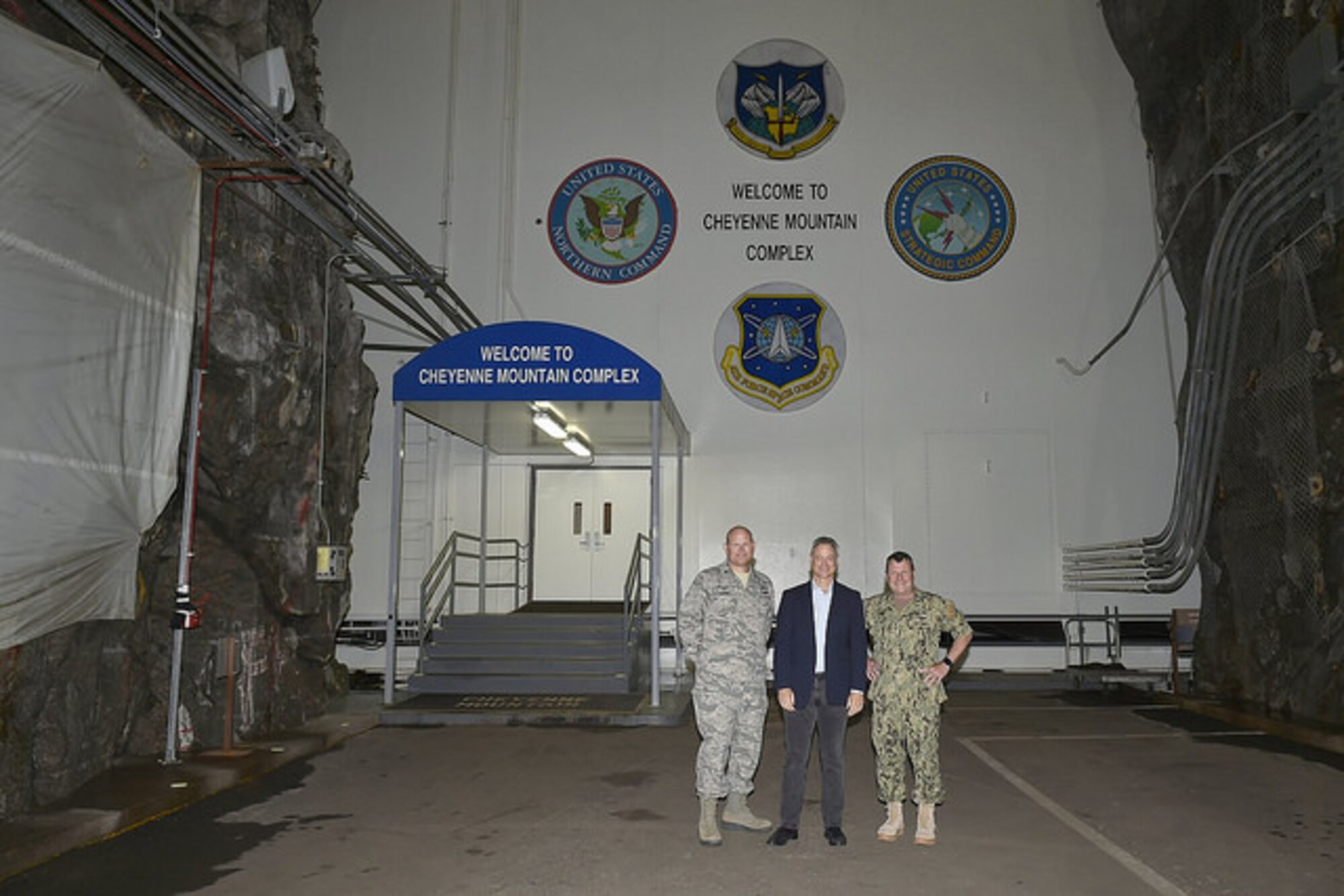 CHEYENNE MOUNTAIN AIR FORCE STATION, Colo. - Col. Gary L. Cornn, Jr., (left) commander, 721st Mission Support Group and Cheyenne Mountain Air Force Station Installation Commander, Gary Sinise (center), actor and founder of Gary Sinise Foundation , and U.S. Navy Adm. Bill Gortney, commander, North American Aerospace Defense Command and U.S. Northern Command, stop for a photo prior to touring the Cheyenne Mountain Air Force Station Complex on Aug. 9, 2015. (courtesy photo)
