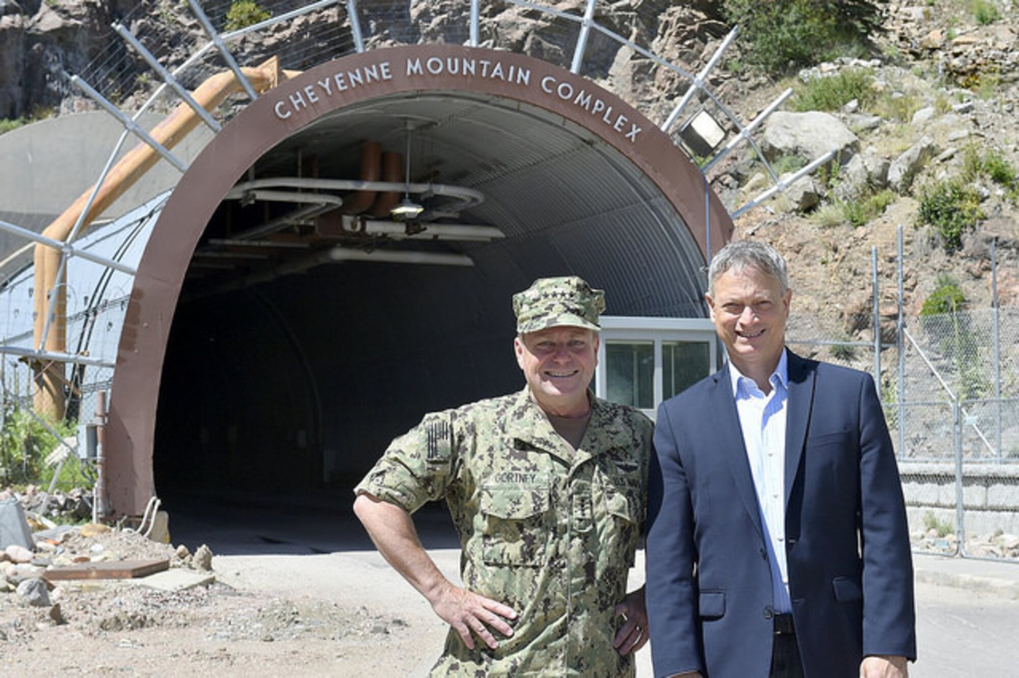 CHEYENNE MOUNTAIN AIR FORCE STATION, Colo. – U.S. Navy Adm. Bill Gortney, commander, North American Aerospace Defense Command and U.S. Northern Command, and Gary Sinise, actor and founder of the Gary Sinise Foundation, pause for a photo opportunity at the North Portal of Cheyenne Mountain on Aug. 9, 2015.  An advocate of America’s servicemen and women, Sinise wanted to personally thank the troops assigned to CMAFS for the sacrifices that they, and their families, make every day to serve our nation. (courtesy photo)