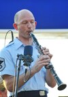 Senior Master Sgt. David K. Stump, U.S. Air Force Concert Band member plays the bass clarinet at the National Harbor Plaza stage, MD on Aug. 15, 2015. The Concert Band and Singing Sergeants performed at the National Harbor.  The performance commemorated the 70th anniversary of the end of World War II and celebrated "The Greatest Generation," featuring music from or related to the World War II era and was in honor of our World War II veterans. The Concert Band and Singing Sergeants are stationed at Joint Base Anacostia-Bolling in Washington, D.C. (U.S. Air Force photo/James E. Lotz). 