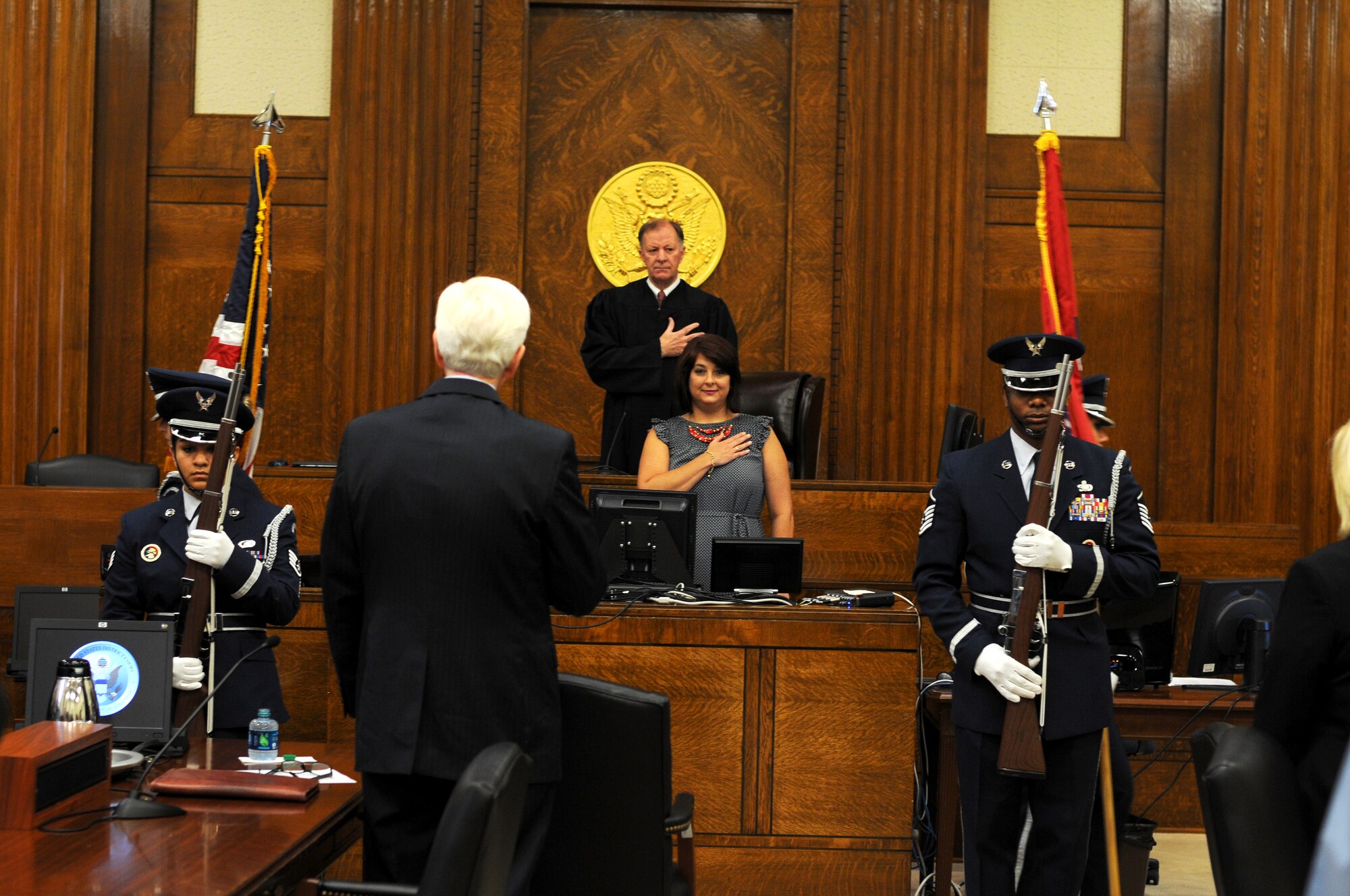 Members of the 188th Wing Honor Guard present the colors during a naturalization ceremony at the federal courthouse in Fort Smith, Ark., Aug. 14, 2015. Master Sgt. Brian Mays, 188th Force Support Squadron, Master Sgt. Lindsey Mott, 188th Force Support Squadron, Staff Sgt. Julie Darrough, 123rd Intelligence Squadron, and Staff Sgt. Hannah Dickerson, 188th Wing Public Affairs group, are the event’s ceremonial protectors of the colors, also known as Ceremonial Guardsman. These Airmen volunteer for this duty to honor a rich history of courage and tradition. (U.S. Air National Guard photo by Senior Airman Cody Martin/released)