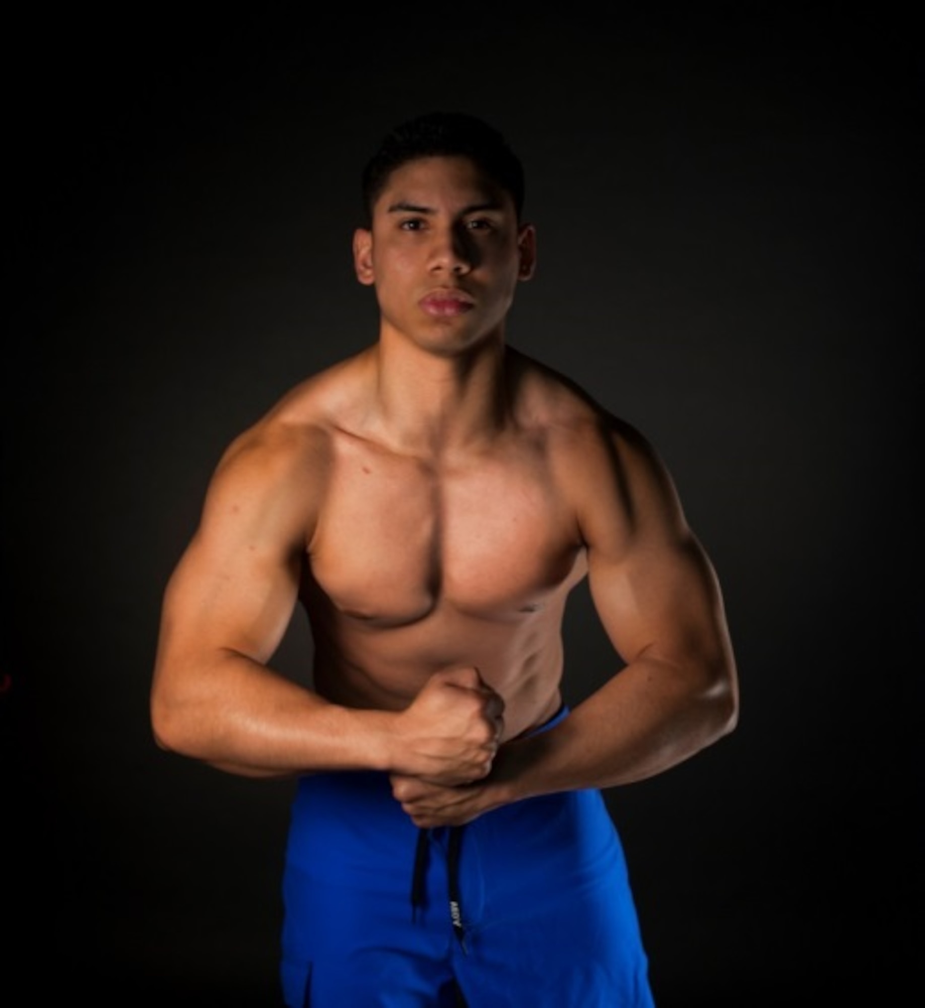 Senior Airman Miguel Amador, 5th Medical Group medical information service technician, flexes his muscles at Minot Air Force Base, N.D., Aug. 11, 2015. Amador has begun training for his next bodybuilding competition, which begins in October. (U.S. Air Force photo/Airman 1st Class Christian Sullivan) 
