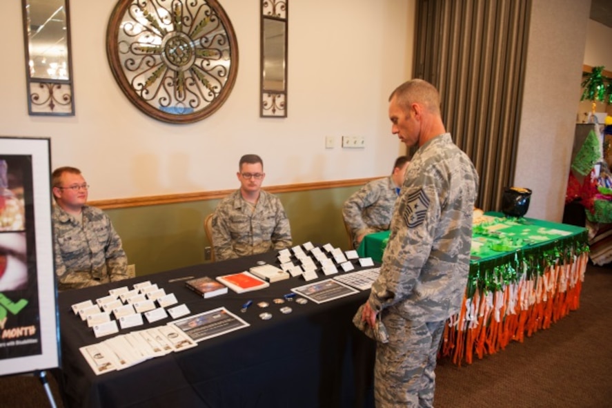 Chief Master Sgt. Geoff Weimer, 5th Bomb Wing command chief, talks to Airmen at the physically disabled booth during Diversity Day at Minot Air Force Base, N.D., Aug. 14, 2015. Diversity Day showcased many different cultures along with other diversities such as religion and disabilities. (U.S. Air Force photo/Airman 1st Class Christian Sullivan)