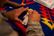 A Minot Airman works on a project at the Native American booth during Diversity Day at Minot Air Force Base, N.D., Aug. 14, 2015. The Native American booth was one of many cultural stations showcased at the event. (U.S. Air Force photo/Airman 1st Class Christian Sullivan)