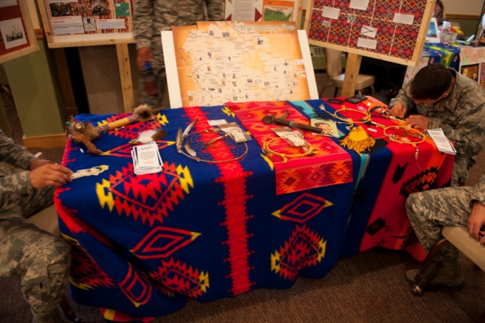Minot Airmen work on projects at the Native American booth during Diversity Day at Minot Air Force Base N.D., Aug. 14, 2015. Many booths showcasing cultures at Diversity Day had items displaying history or a food that originated from that culture. (U.S. Air Force photo/Airman 1st Class Christian Sullivan)
