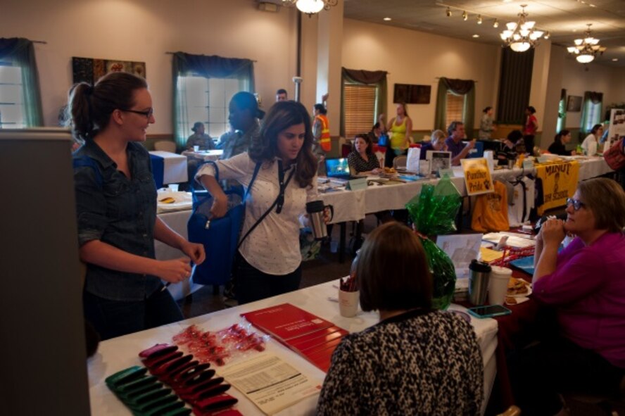 Minot personnel receive information from Minot State University at the education fair at Minot Air Force Base, N.D., Aug. 11, 2015. Minot AFB held an education fair to highlight education opportunities in the Minot area. (U.S. Air Force photo/Airman 1st Class Christian Sullivan)