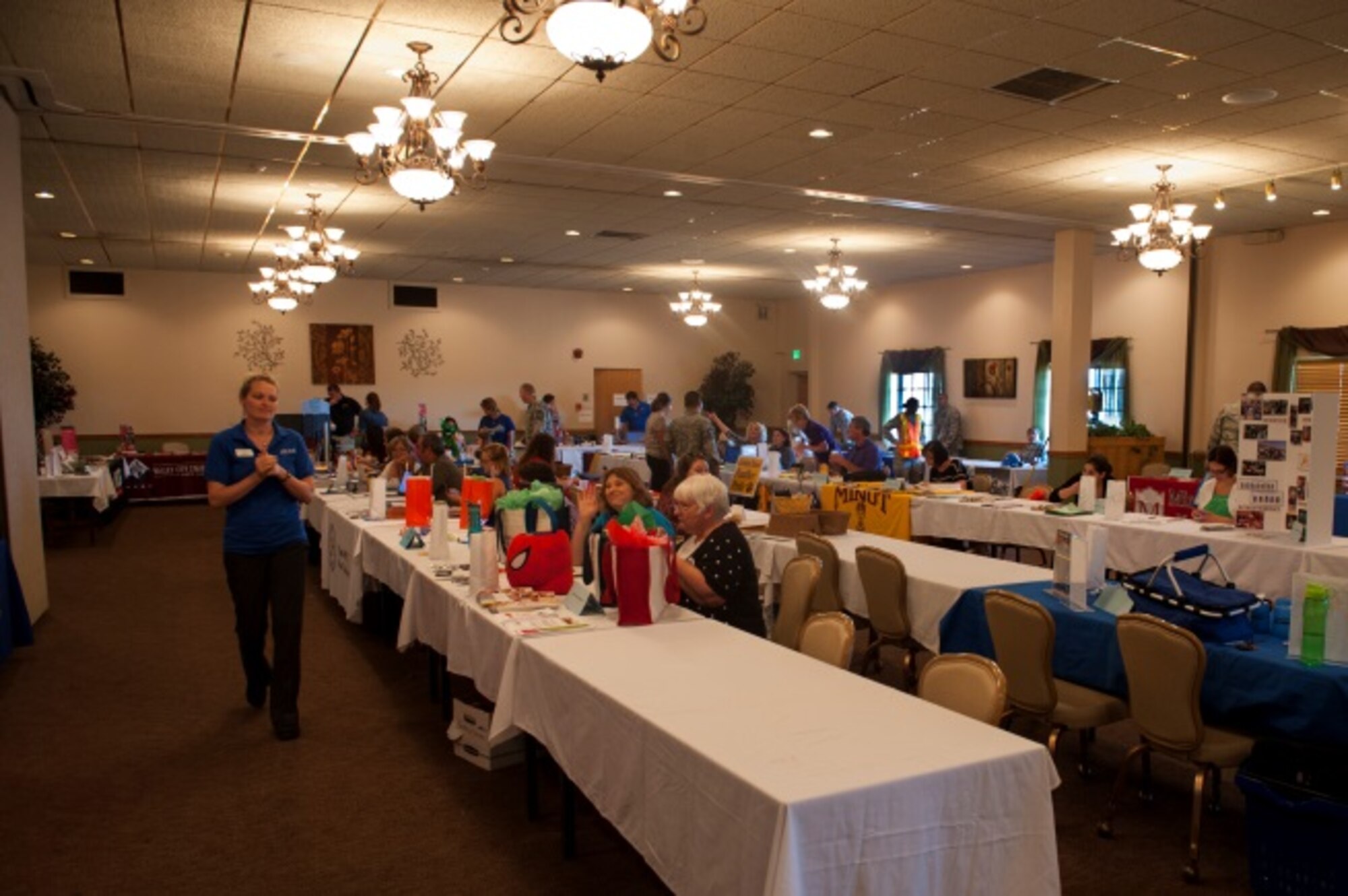Education vendors wait for Airmen to arrive at the education fair at Minot Air Force Base, N.D., Aug. 11, 2015. The education fair had more than 30 education vendors showcase what they have to offer Airmen and their families. (U.S. Air Force photo/Airman 1st Class Christian Sullivan)