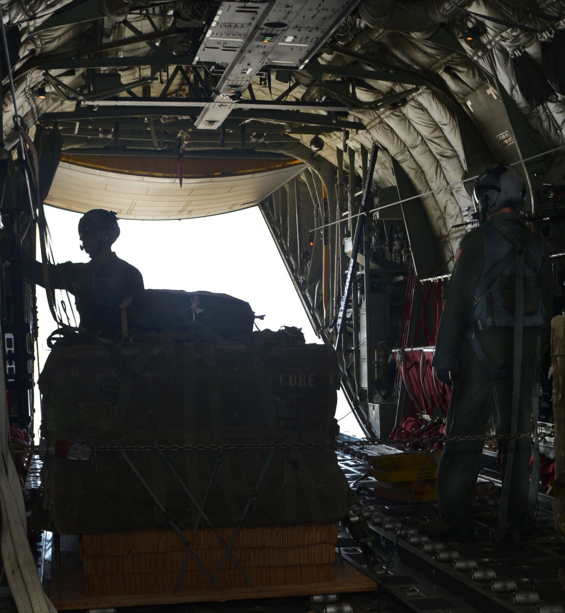U.S. Air Force loadmasters from the 39th Airlift Squadron prepare to drop an Improvised Container Delivery System bundle, July 29, 2015, at Dyess Air Force Base, Texas. An ICDS derives from a traditional Container Delivery System but uses a sonde, an instrument that acts as a Global Positioning System receiver. The sonde is released from the aircraft on the first pass over a drop zone to better calculate the winds throughout the air column. With this information, the aircrew is able to compute a more precise drop point to achieve the most accurate delivery to the drop zone (U.S. Air Force photo by Airman 1st Class Autumn Velez/Released).