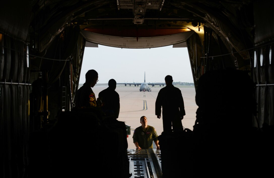 U.S. Air Force loadmasters from the 317th Airlift Group talk as they prepare a C-130J Super Hercules for flight July 29, 2015, at Dyess Air Force Base, Texas. Loadmasters are responsible for performing a variety of airdrops including Joint Precision Airdrop System bundles, which use the Global Positioning System to accurately deliver bundles to designated drop zones (U.S. Air Force photo by Airman 1st Class Autumn Velez/Released).