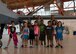 Children from the Holloman Youth Center pose with Senior Airman Elijah Rogers and Jason Lewis, 49th Aircraft Maintenance Squadron, in front of the MQ-9 Reaper after their visit at Holloman Air Force Base, N.M. on Aug. 12. The youth center received a hands on tour of Holloman to learn about the various missions Team Holloman supports. The tour was also part of the Tuskegee Airmen Initiative that supports children’s interest and knowledge in fields of aviation. (U.S. Air Force photo by Senior Airman Leah Ferrante)  