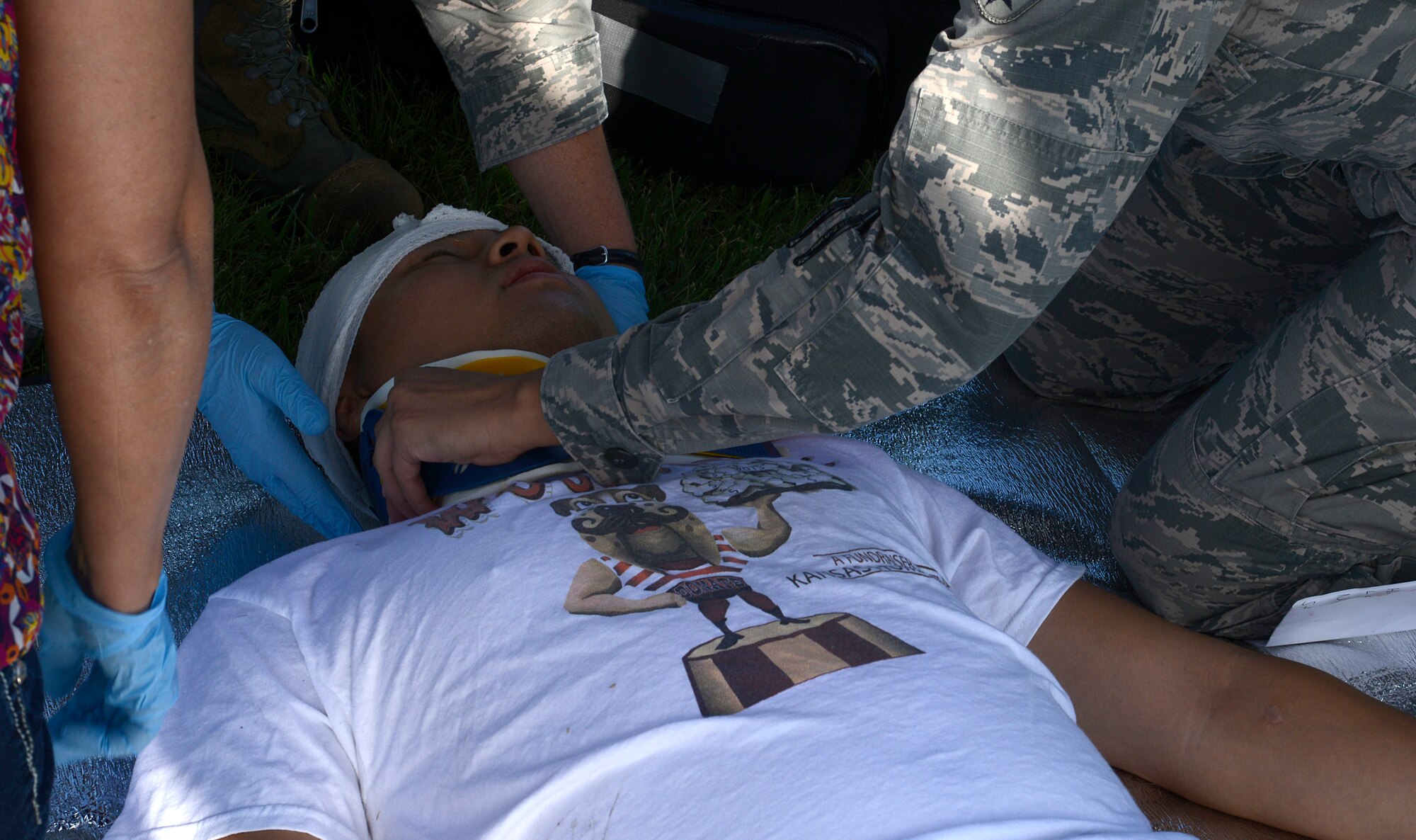 First responders from the 22nd Medical Group place a neck brace on a simulated patient during a mass-casualty exercise, Aug. 13, 2015, at McConnell Air Force Base, Kan. The exercise provided hands-on training for situations that are not handled on a day-to-day basis for healthcare providers in the 22nd MDG. (U.S. Air Force photo by Senior Airman Trevor Rhynes)