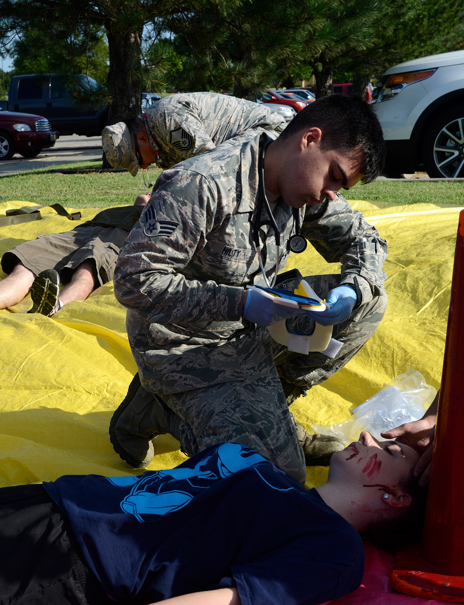 Senior Airman Justin Hilty, 22nd Aerospace Medicine Squadron aerospace medical technician, reviews a simulated patient’s injuries during a mass-casualty exercise, Aug. 13, 2015, at McConnell Air Force Base, Kan. Information about injuries are tracked and used by medical technicians to determine the level of care. (U.S. Air Force photo by Senior Airman Trevor Rhynes)