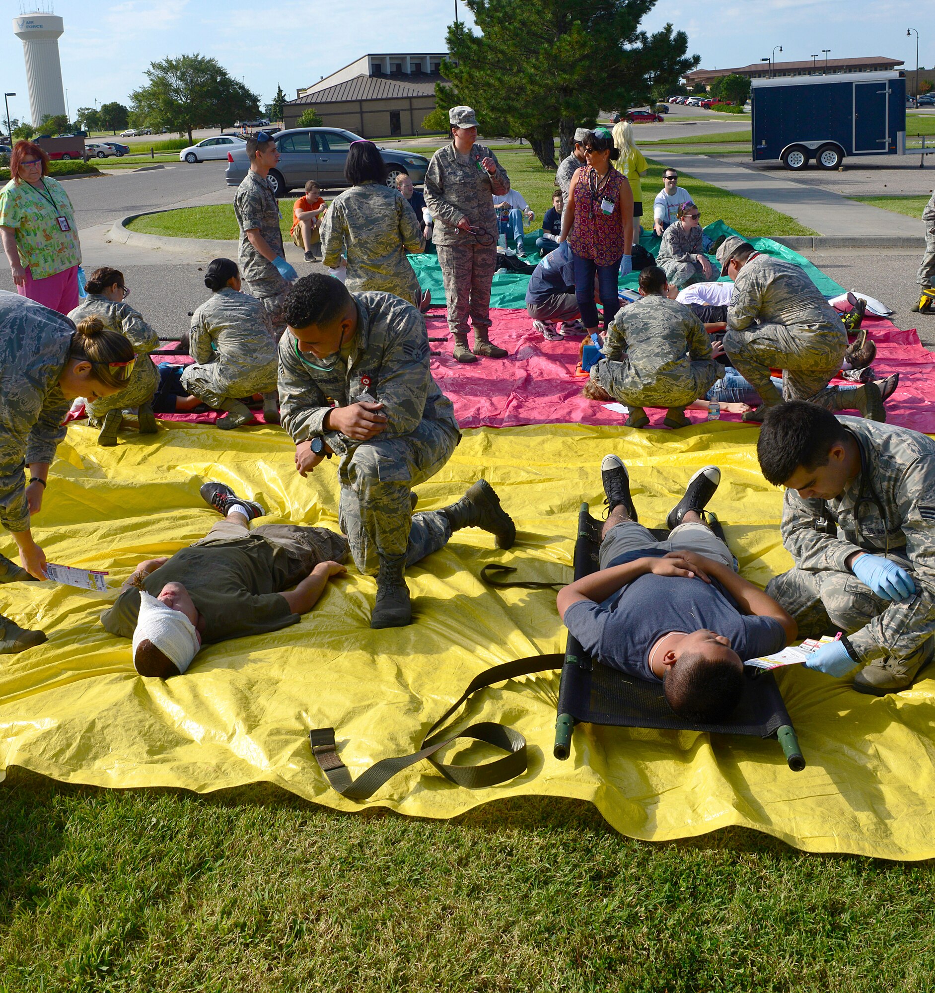 Medical professionals from the 22nd Medical Group treat simulated patients at a casualty collection point during a mass-casualty exercise, Aug. 13, 2015, at McConnell Air Force Base, Kan. Casualty collection points are a staging area used to stabilize patients during a disaster before being transported to a medical treatment facility. (U.S. Air Force photo by Senior Airman Trevor Rhynes) 