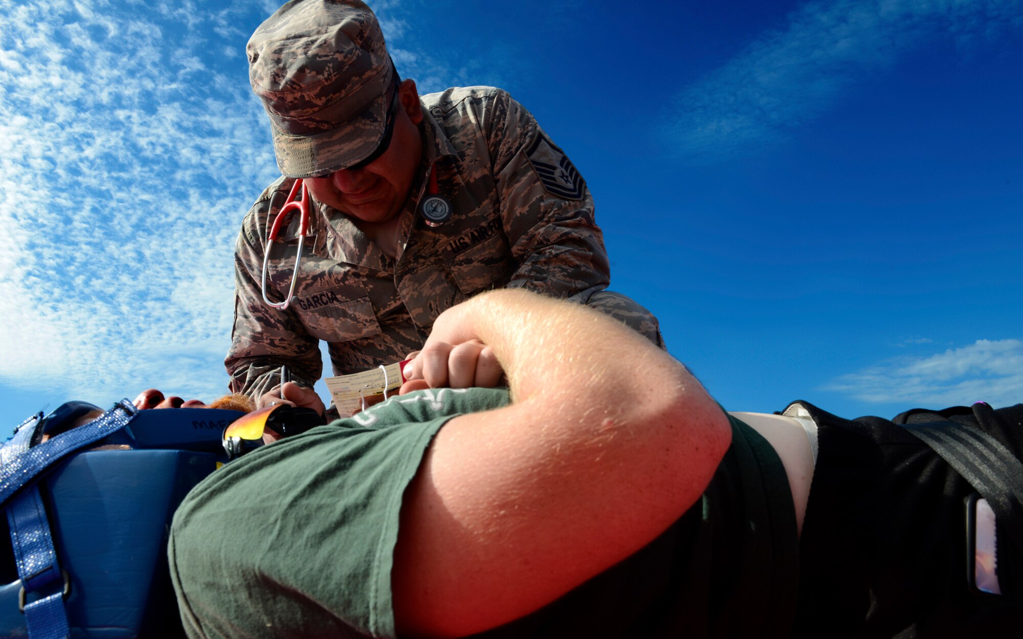 Master Sgt. Benjamin Garcia, 22nd Aerospace Medicine Squadron independent duty medical technician, stabilizes a simulated patient during a mass-casualty exercise, Aug. 13, 2015, at McConnell Air Force Base, Kan. The exercise provided an opportunity for 22nd Medical Group medical professionals to practice recovering and treating victims as well as working with the local community to provide a higher level of care. (U.S. Air Force photo by Senior Airman Trevor Rhynes) 