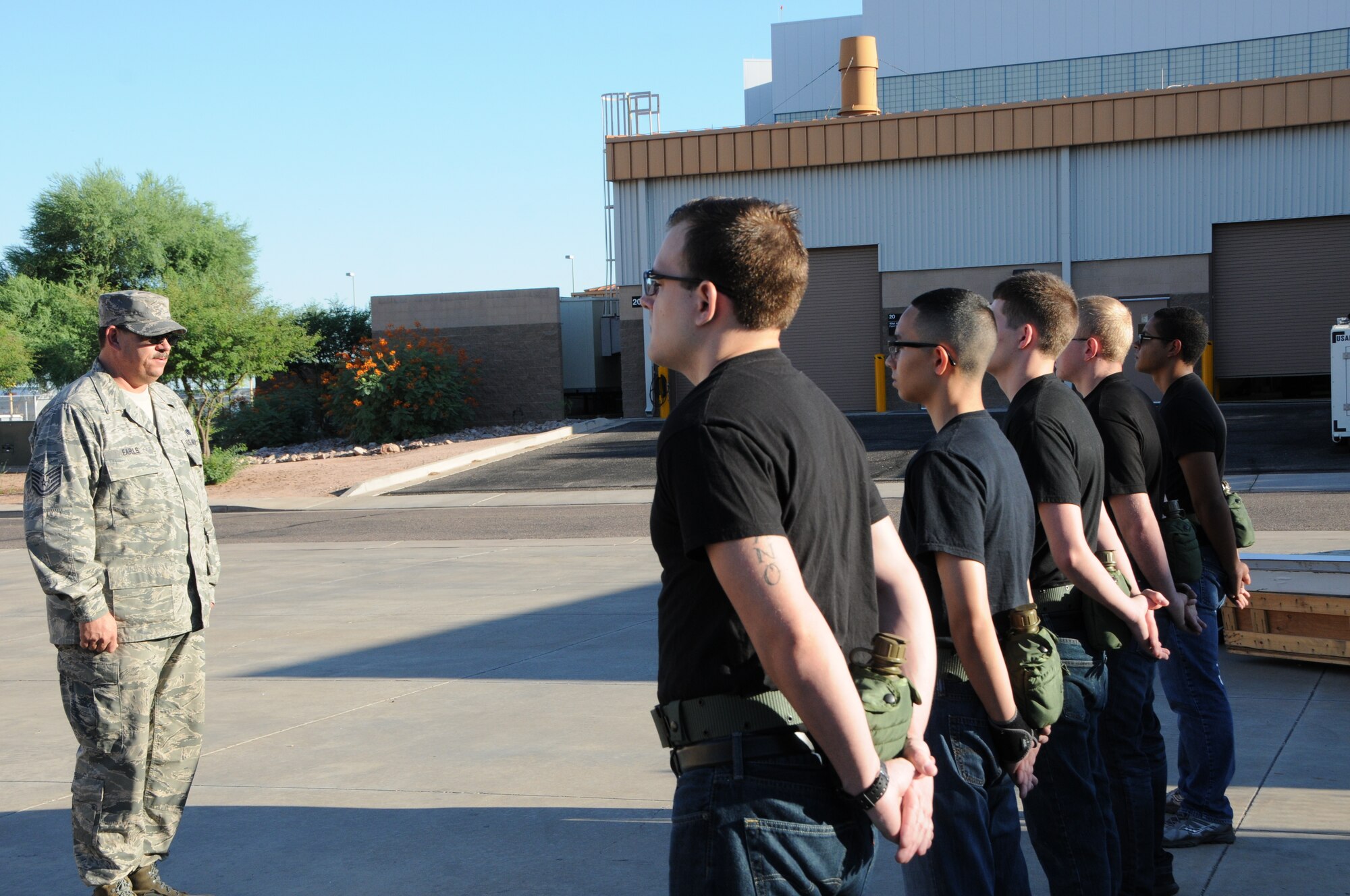 Tech. Sgt. Bret Earls, 161st Air Refueling Wing student flight instructor and former U.S. Army drill instructor, inspects a formation of trainees at the Phoenix Air National Guard Base, Aug. 2. The main purpose of the student flight is to in-process new recruits into the wing and then out-process them to basic training and technical school; however, a secondary benefit is the mentorship the trainees receive from the student flight’s instructors. (U.S. Air National Guard photo by Tech. Sgt. Michael Matkin)