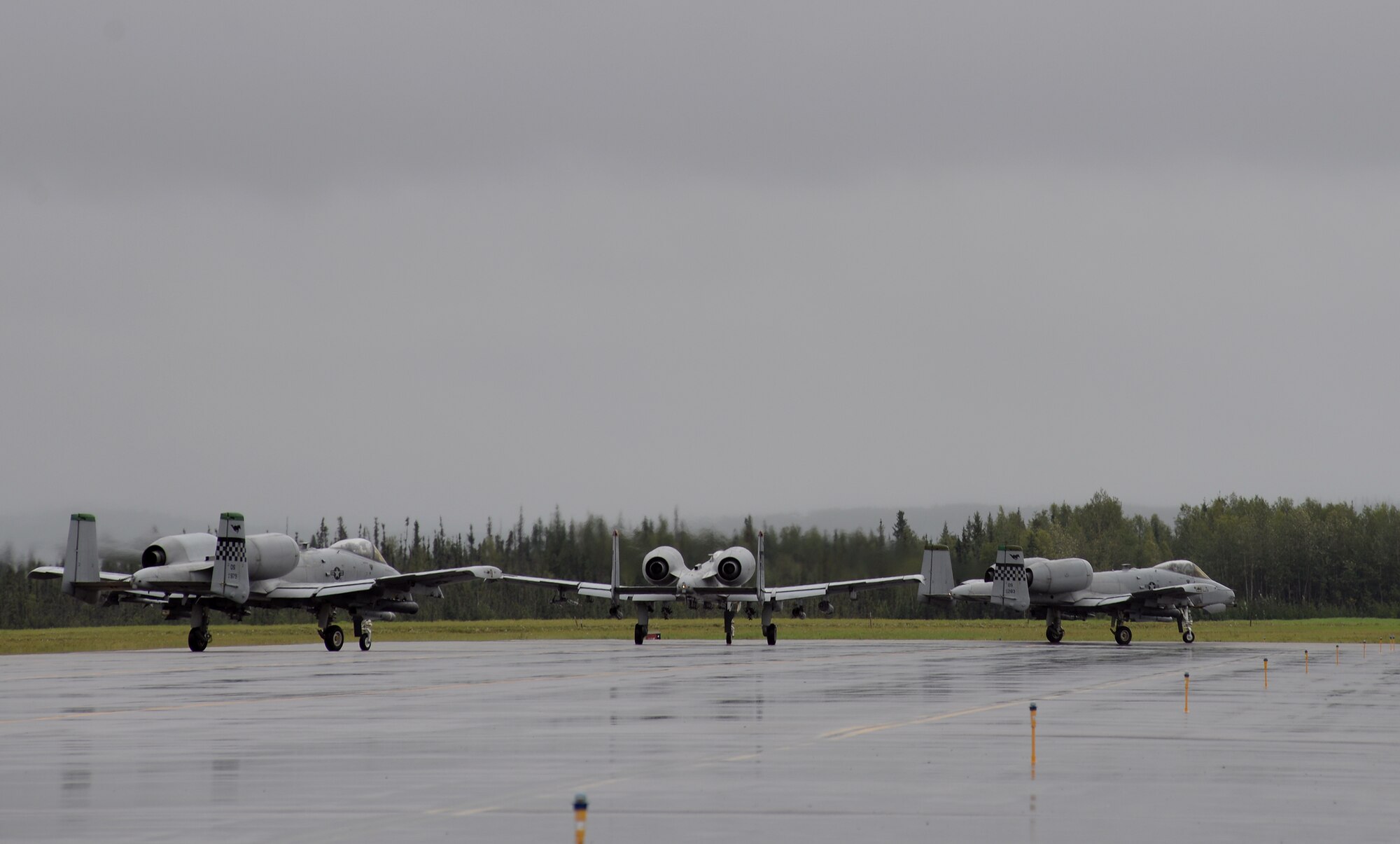 U.S. Air Force A-10 Thunderbolt II aircraft with the 25th Fighter Squadron from Osan Air Base, Republic of Korea, taxi to Eielson Air Force Base, Alaska, runway Aug. 10, 2015, to participate in the first simulated combat sortie of RED FLAG-Alaska (RF-A) 15-3. The Osan A-10s, as well as several F-16 Fighting Falcons from Osan's 36th Fighter Squadron, are deployed to Eielson for RF-A, a series of Pacific Air Forces commander-directed field training exercises for U.S. and partner nation forces, providing combined offensive counter-air, interdiction, close air support, and large force employment training in a simulated combat environment. (U.S. Air Force photo by Master Sgt. Karen J. Tomasik/Released)