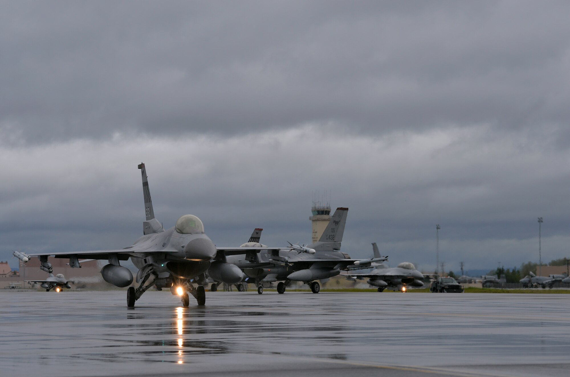 U.S. Air Force F-16 Fighting Falcons with the 36th Fighter Squadron from Osan Air Base, Republic of Korea, taxi toward the end of the flightline in preparation for the first simulated combat sortie of RED FLAG-Alaska (RF-A) 15-3 from Eielson Air Force Base, Alaska, Aug. 10, 2015. The Osan F-16s, as well as several A-10 Thunderbolt II aircraft from Osan's 25th Fighter Squadron, are deployed to Eielson for RF-A, a series of Pacific Air Forces commander-directed field training exercises for U.S. and partner nation forces, providing combined offensive counter-air, interdiction, close air support, and large force employment training in a simulated combat environment. (U.S. Air Force photo by Master Sgt. Karen J. Tomasik/Released)