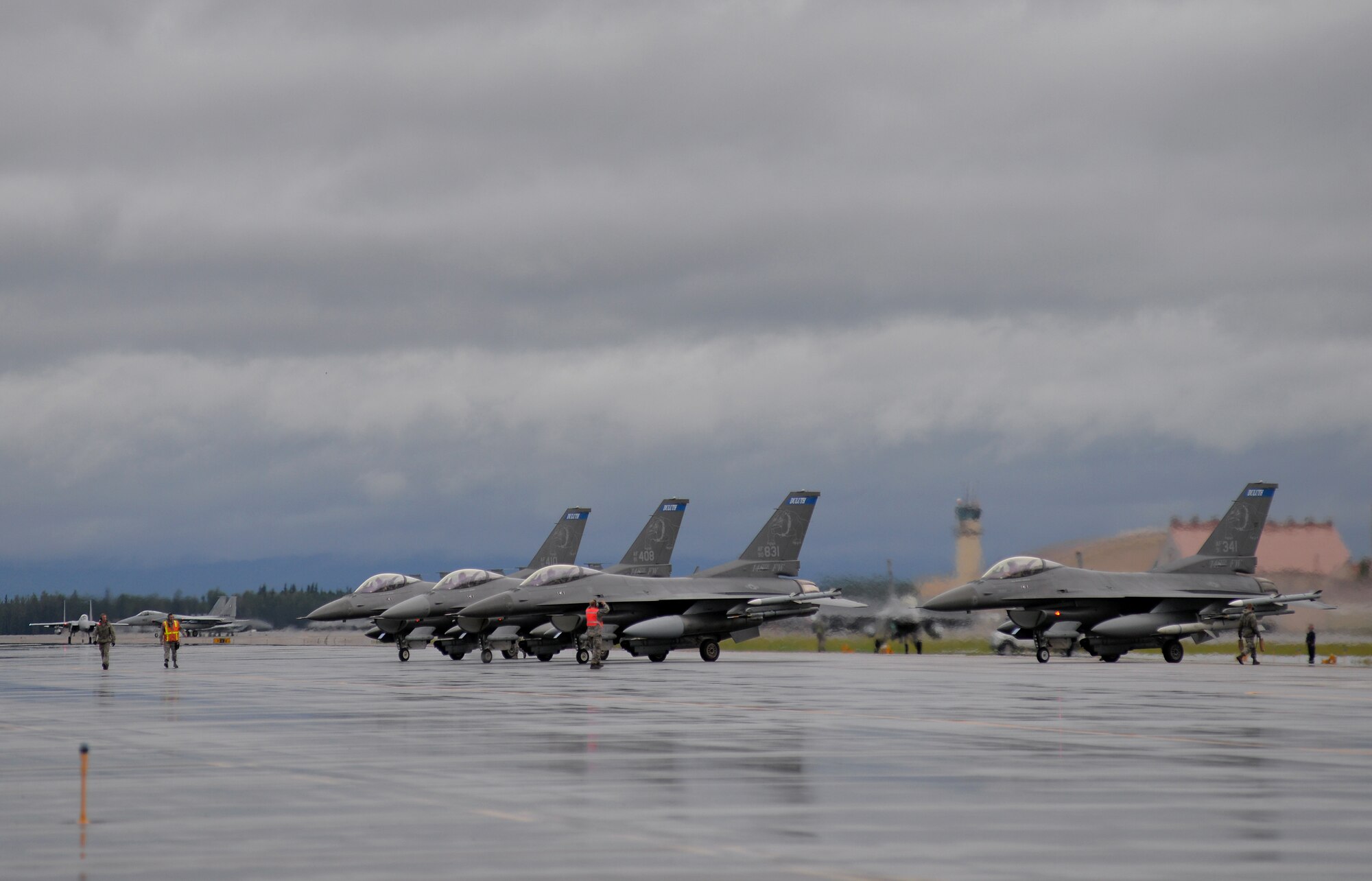 U.S. Air Force F-16 Fighting Falcons assigned to the Minnesota Air National Guard's 148th Fighter Wing out of Duluth, Minn., and Japan Air Self-Defense Force (JASDF) F-15J Eagles taxi into their holding areas Aug. 10, 2015, at Eielson Air Force Base, Alaska, to prepare for the first simulated combat sortie of RED FLAG-Alaska 15-3. The Minnesota ANG and JASDF units are participating in this Pacific Air Forces commander-directed field training exercise for U.S. and partner nation forces, providing combined offensive counter-air, interdiction, close air support, and large force employment training in a simulated combat environment. (U.S. Air Force photo by Master Sgt. Karen J. Tomasik/Released)