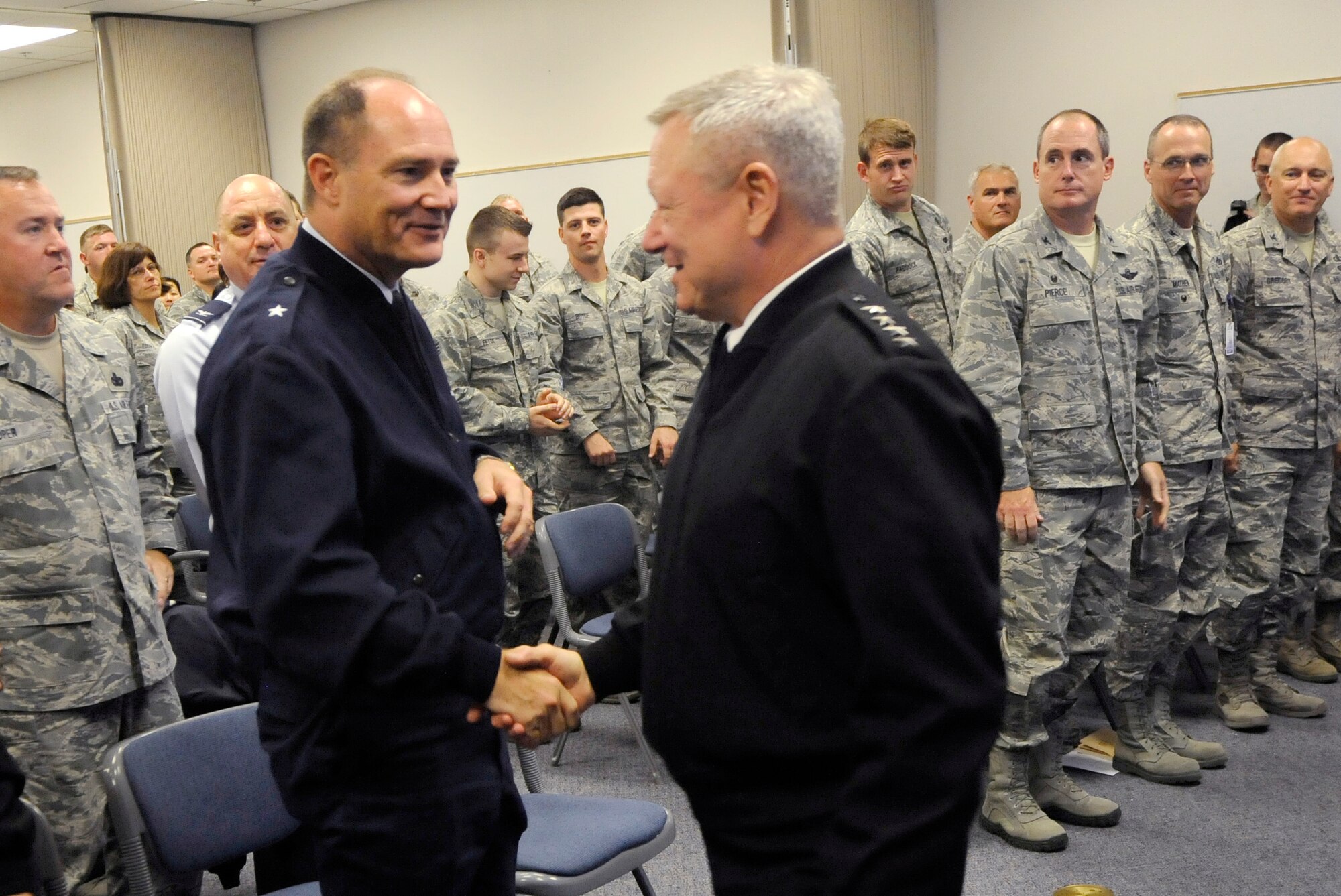 Army Gen. Frank J. Grass, Director of the National Guard Bureau, right, acknowledges Brig. Gen. Michael Stencel, left, on becoming the interim Adjutant General for Oregon earlier in the day during a town hall event at the Portland Air National Guard Base, Ore. (U.S. Air National Guard photo by Tech. Sgt. John Hughel, 142nd Fighter Wing Public Affairs/Released)