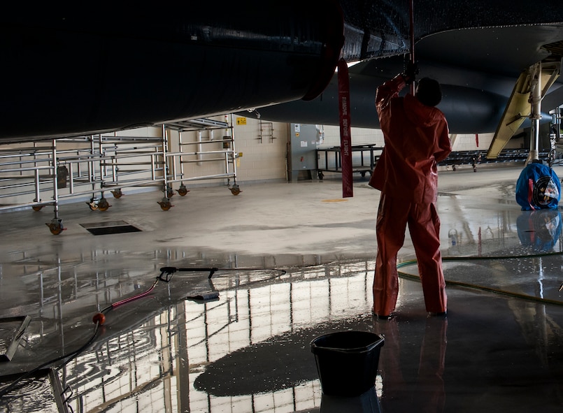 A 5th Maintenance Squadron crew chief scrubs under the wing of a B-52H Stratofortress at Minot Air Force Base, N.D., Aug. 4, 2015. The Airman used a cleaning solution designed to remove dirt and grime that the aircraft picks up while on the ground and from the engines during flight. (U.S. Air Force photo/Senior Airman Stephanie Morris)