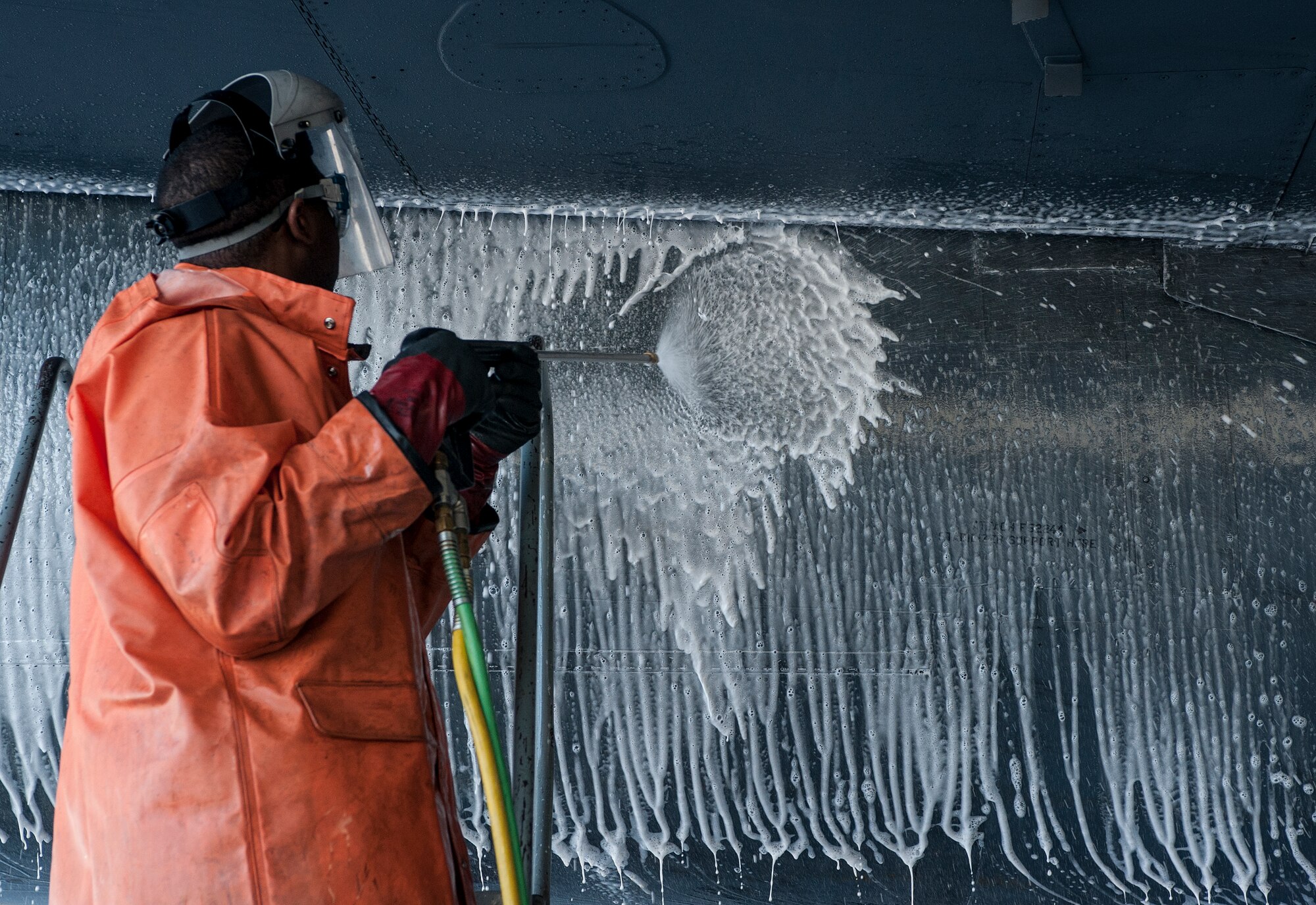 Senior Airman Taylor Grier, 5th Maintenance Squadron crew chief, sprays a cleaning solution onto a B-52H Stratofortress at Minot Air Force Base, N.D., Aug. 4, 2015. The solution is designed to remove dirt and grime that the aircraft picks up while on the ground and from the engines during flight. (U.S. Air Force photo/Senior Airman Stephanie Morris)