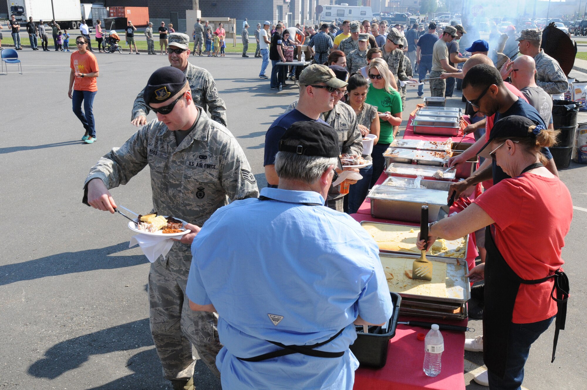 Airmen and their families wait in line during a steak feed at Eielson Air Force Base, Alaska, Aug. 7, 2015.  The Steak Team Mission served 2,000 steaks to Airmen from Eielson AFB and military units participating in RED FLAG-Alaska 15-3 to show appreciation for their service.  (U.S. Air Force photo by Master Sgt. Ralph J. Kapustka/Released)