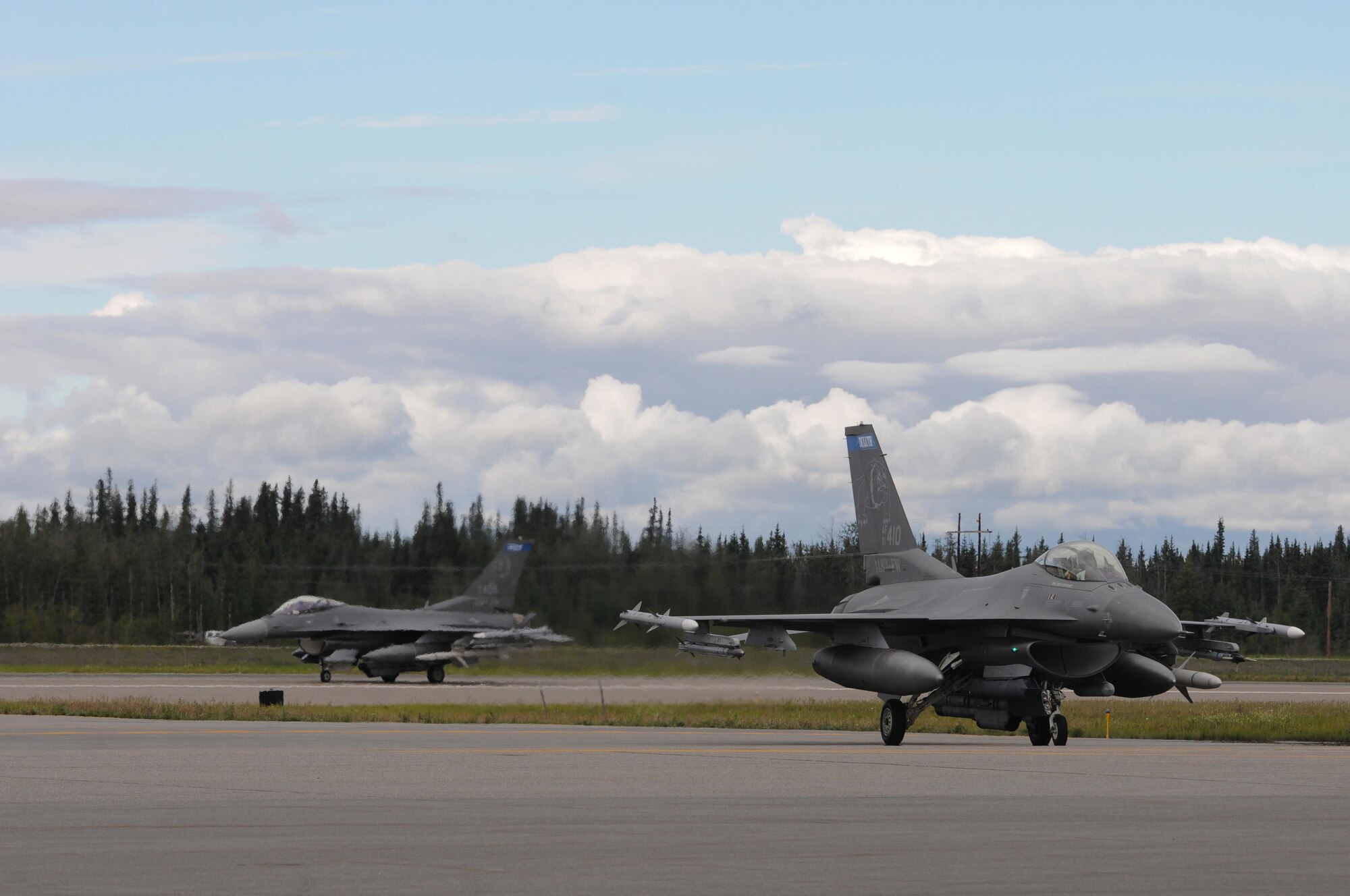 U.S. Air Force F-16 Fighting Falcons from the 148th Fighter Wing, Duluth, Minn., taxi on to the ramp at Eielson Air Force Base, Alaska, Aug. 11, 2015, during RED FLAG-Alaska 15-3.  RF-A is a Pacific Air Forces commander-directed field training exercise for U.S. and partner nation forces, providing combined offensive counter-air, interdiction, close air support and large force employment training in a simulated combat environment.  (U.S. Air Force photo by Master Sgt. Ralph Kapustka/Released)