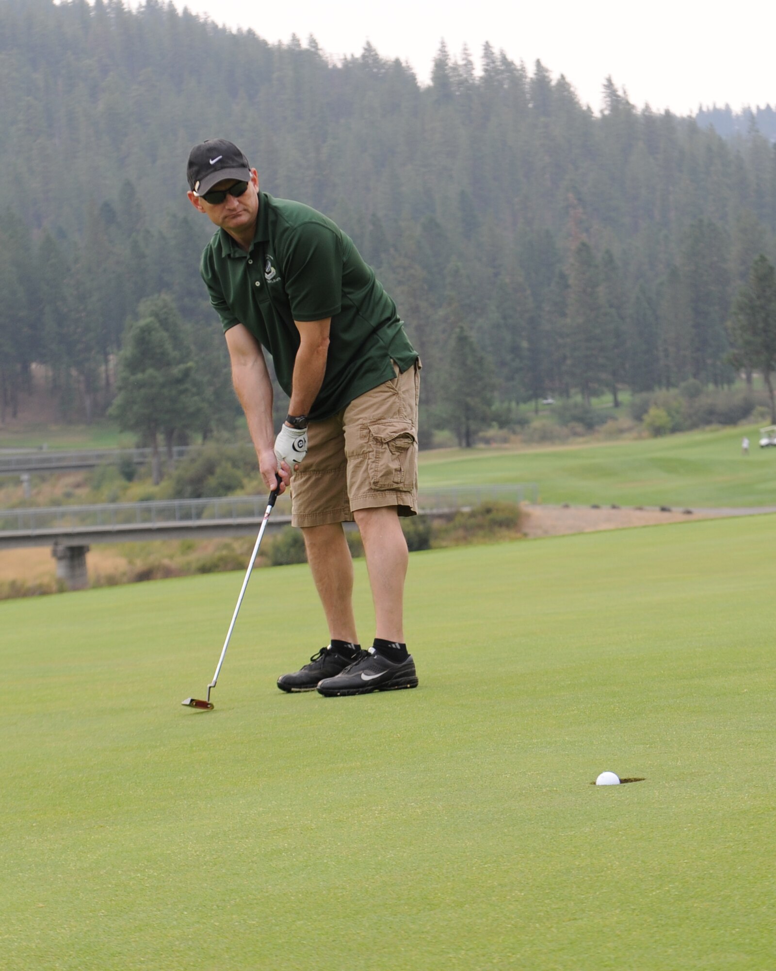 Chief Master Sgt. Christian Pugh, 92nd Air Refueling Wing command chief, watches as his golf balls sinks into the hole Aug. 14, 2015, at Qualchan Golf Course in Spokane, Wash. Airmen from around the base participated in the golf tournament and a prize raffle that closed out the day. (U.S. Air Force photo/Airman 1st Class Nicolo J. Daniello) 