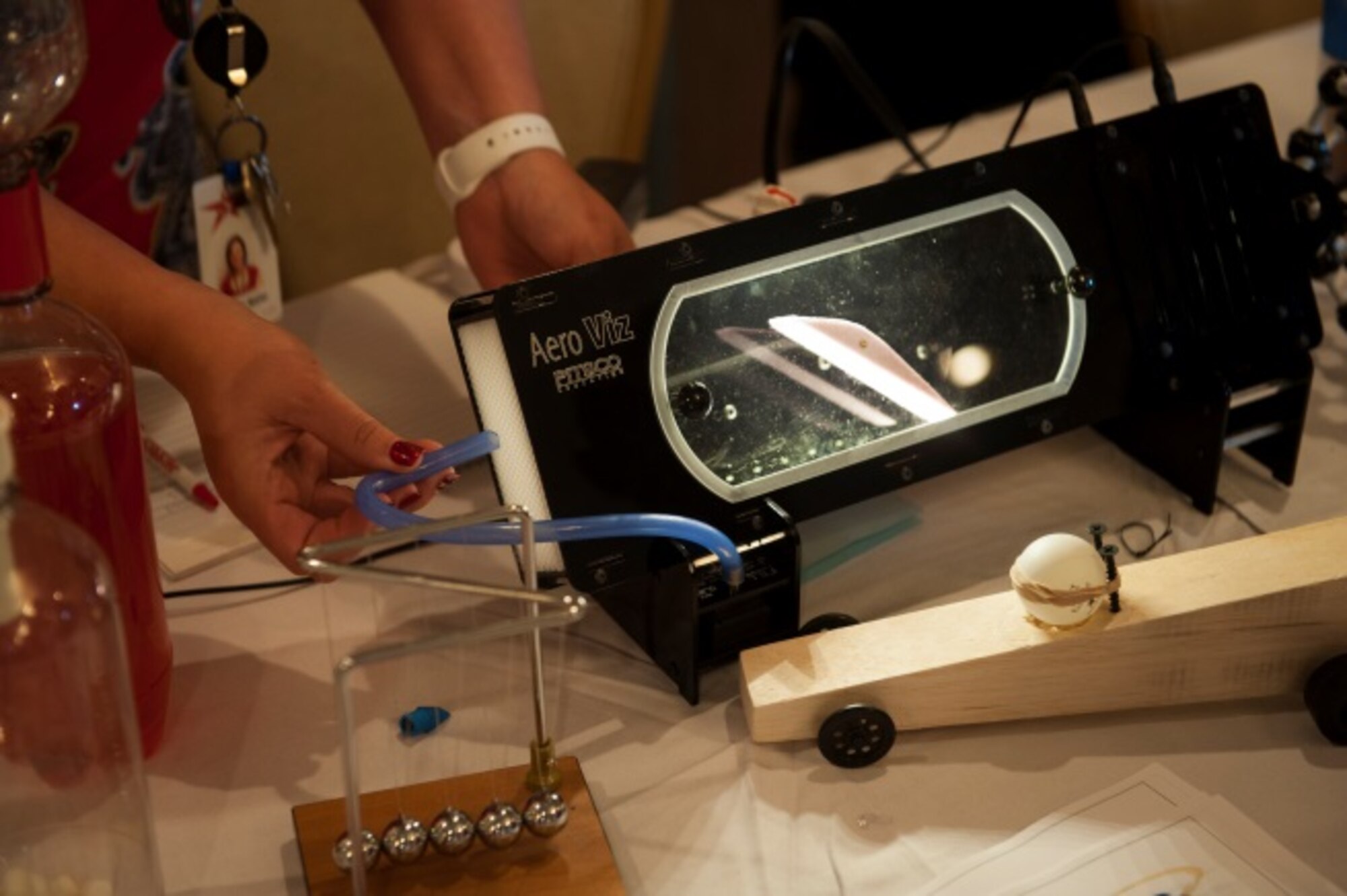 A member from STARBASE, a Department of Defense youth program, demonstrates a model at the education fair at Minot Air Force Base, N.D., Aug. 11, 2015. Minot AFB held an education fair to highlight education opportunities in the Minot area. (U.S. Air Force photo/Airman 1st Class Christian Sullivan)