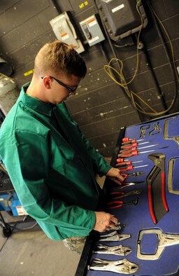 Airman 1st Class Devin Painter, 5th Maintenance Squadron aircraft metals technician, puts away tools at Minot Air Force Base, N.D., Aug. 14, 2015. Originally from Phoenix, Ariz., Painter has been working as a 5th MXS metals technician for approximately two months. (U.S. Air Force photo/Senior Airman Stephanie Morris)
