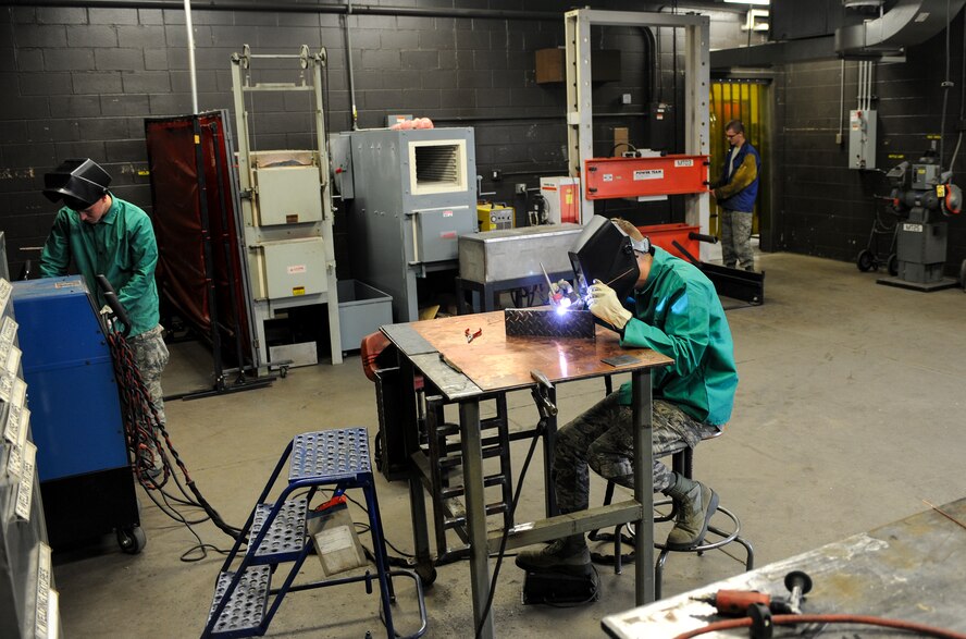 Airmen from the 5th Maintenance Squadron, work on creating a new storage rack at Minot Air Force Base, N.D., Aug. 14, 2015. The 5th MXS fabrication section provides a wide array of services including welding, metal fabrication, corrosion prevention and non-destructive inspections. (U.S. Air Force photo/Senior Airman Stephanie Morris)