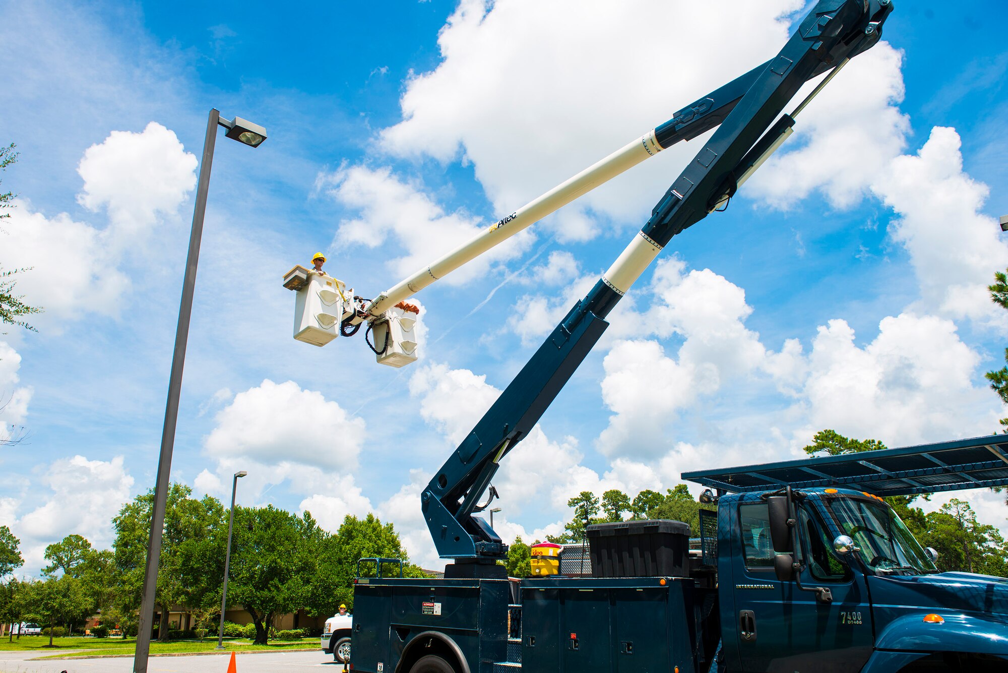 U.S. Air Force Senior Airman Richard Chandlee, 23d Civil Engineer Squadron electrical systems specialist, prepares to install a photocell Aug. 17, 2015, at Moody Air Force Base, Ga. The 23d CES installs photocells in lights to ensure they turn off during daylight hours and on during the night. (U.S. Air Force photo by Airman 1st Class Ceaira Tinsley/Released)