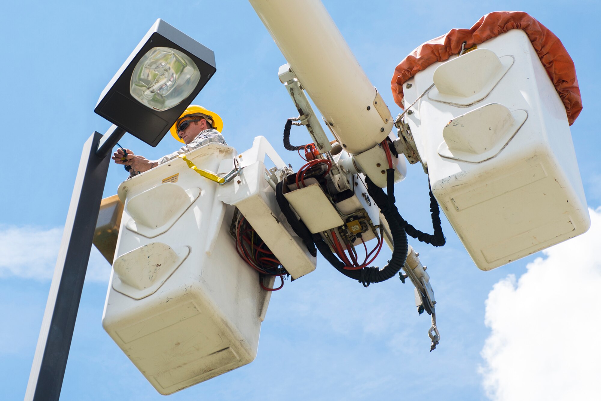 U.S. Air Force Senior Airman Richard Chandlee, 23d Civil Engineer Squadron electrical systems specialist, repairs a light fixture Aug. 17, 2015, at Moody Air Force Base, Ga. The 23d CES electrical shop is responsible for installing, repairing and maintaining all of the bases electrical systems. (U.S. Air Force photo by Airman 1st Class Ceaira Tinsley/Released)